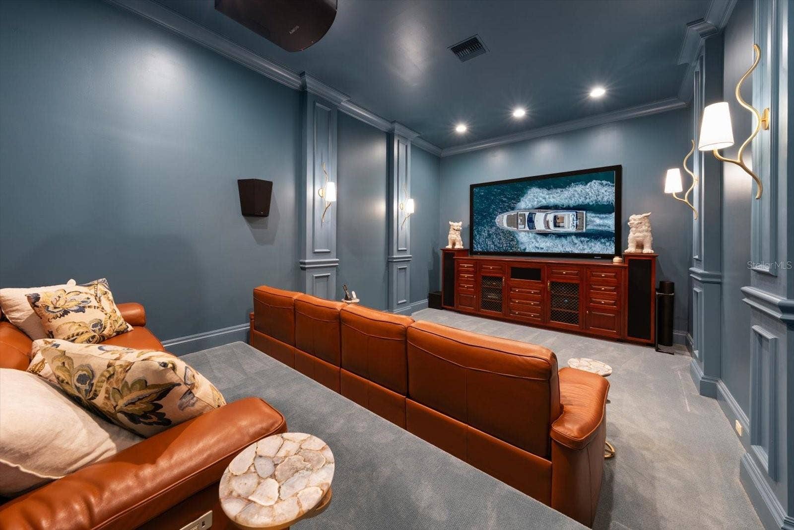2056 COVE TRACE, Palm Harbor, FL 34685 Media Room with a built-in projection screen and sound-blocking insulation with stadium style seating