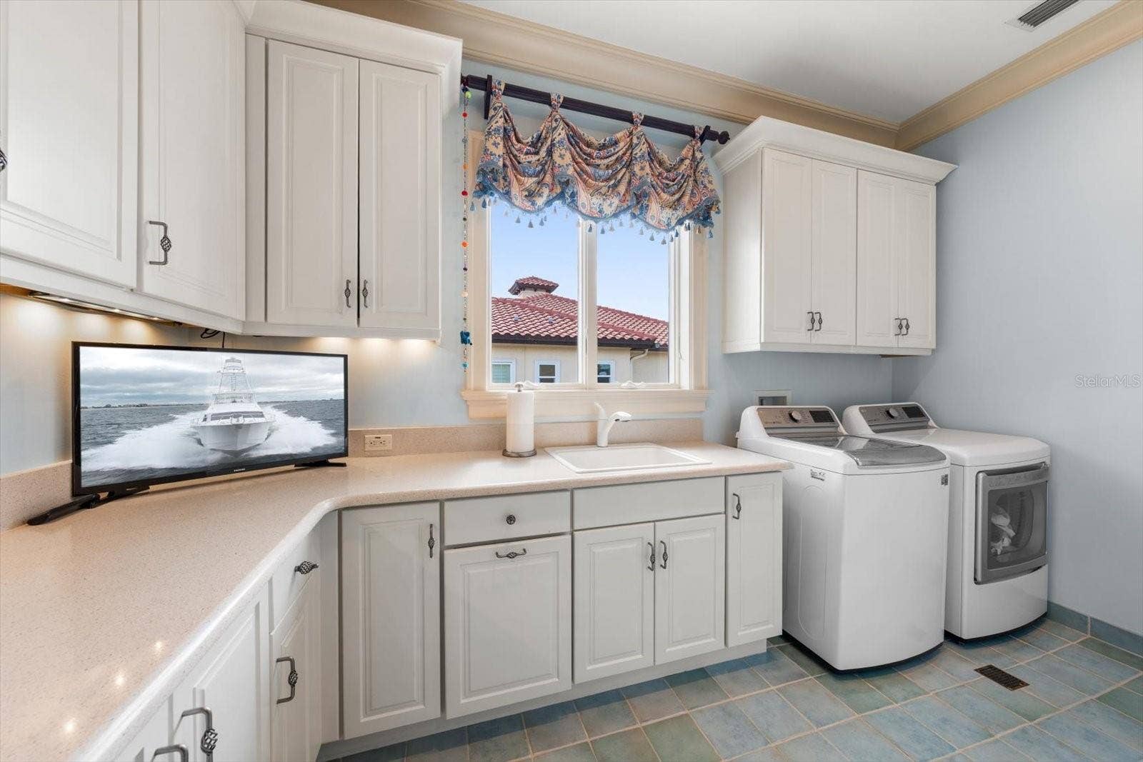 2056 COVE TRACE, Palm Harbor, FL 34685 Oversized Laundry Room with stairs leading to attic space for even more storage!