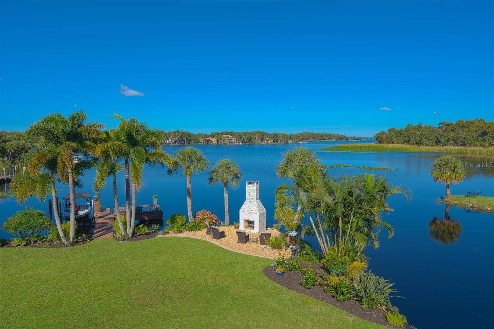 2056 COVE TRACE, Palm Harbor, FL 34685 Unbelievable Views! The romantic see-through wood-burning fireplace adds ambiance to the waterfront setting