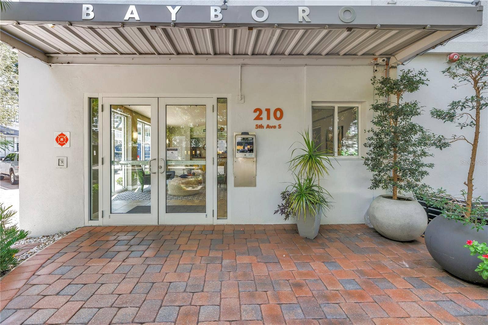 210 5TH AVENUE S, #303, St Petersburg, FL 33701 Front entry. High Tech access to the right of the lobby door. Owners can open the doors remotely using your phone. It's EXTREMELY convenient when receiving deliveries and you are not at home.