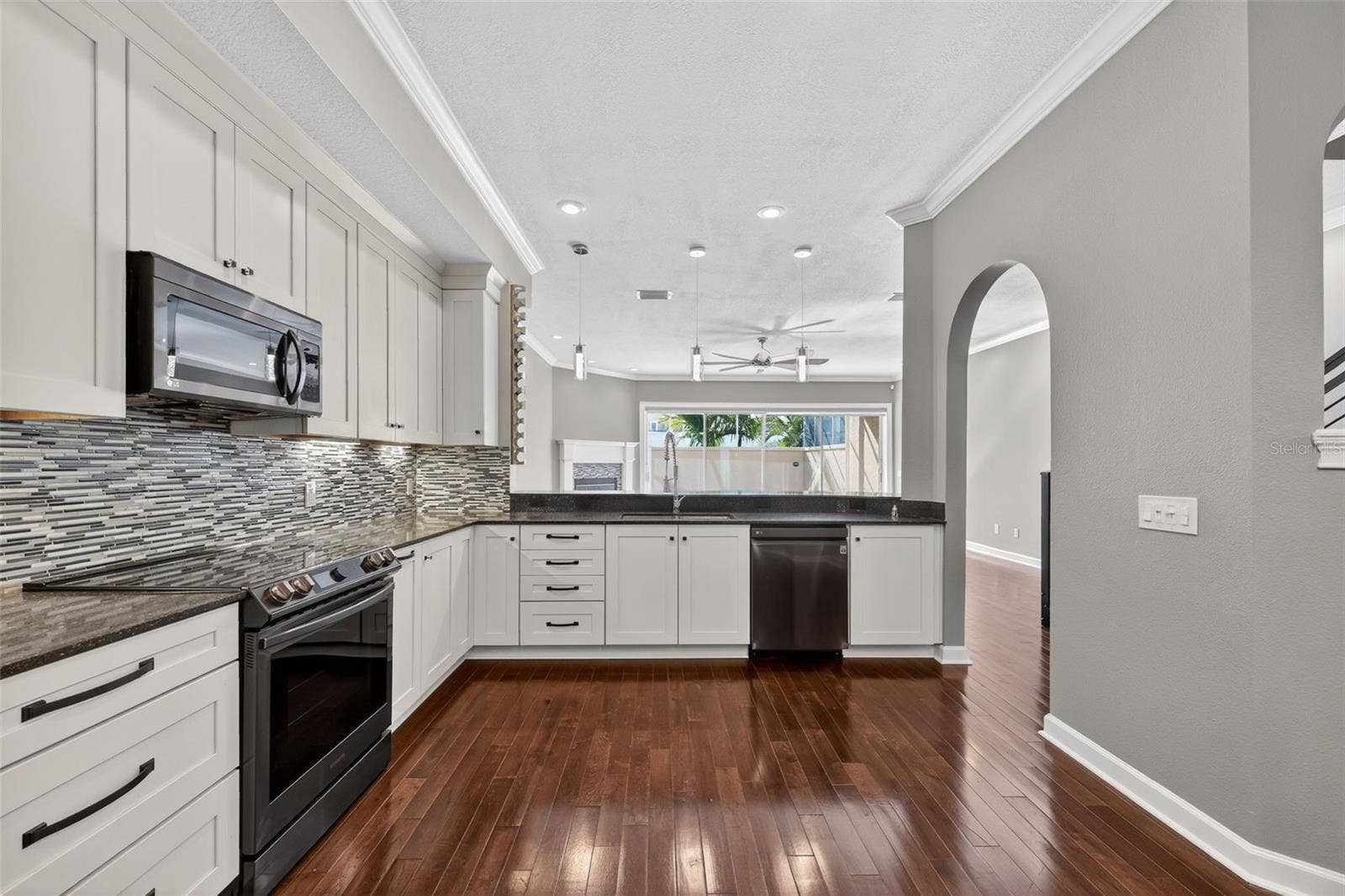 348 LARBOARD WAY, Clearwater, FL 33767 Large kitchen with Pendant lighting and lots of storage, which leads into the dining area and overlooks the Living/Family room