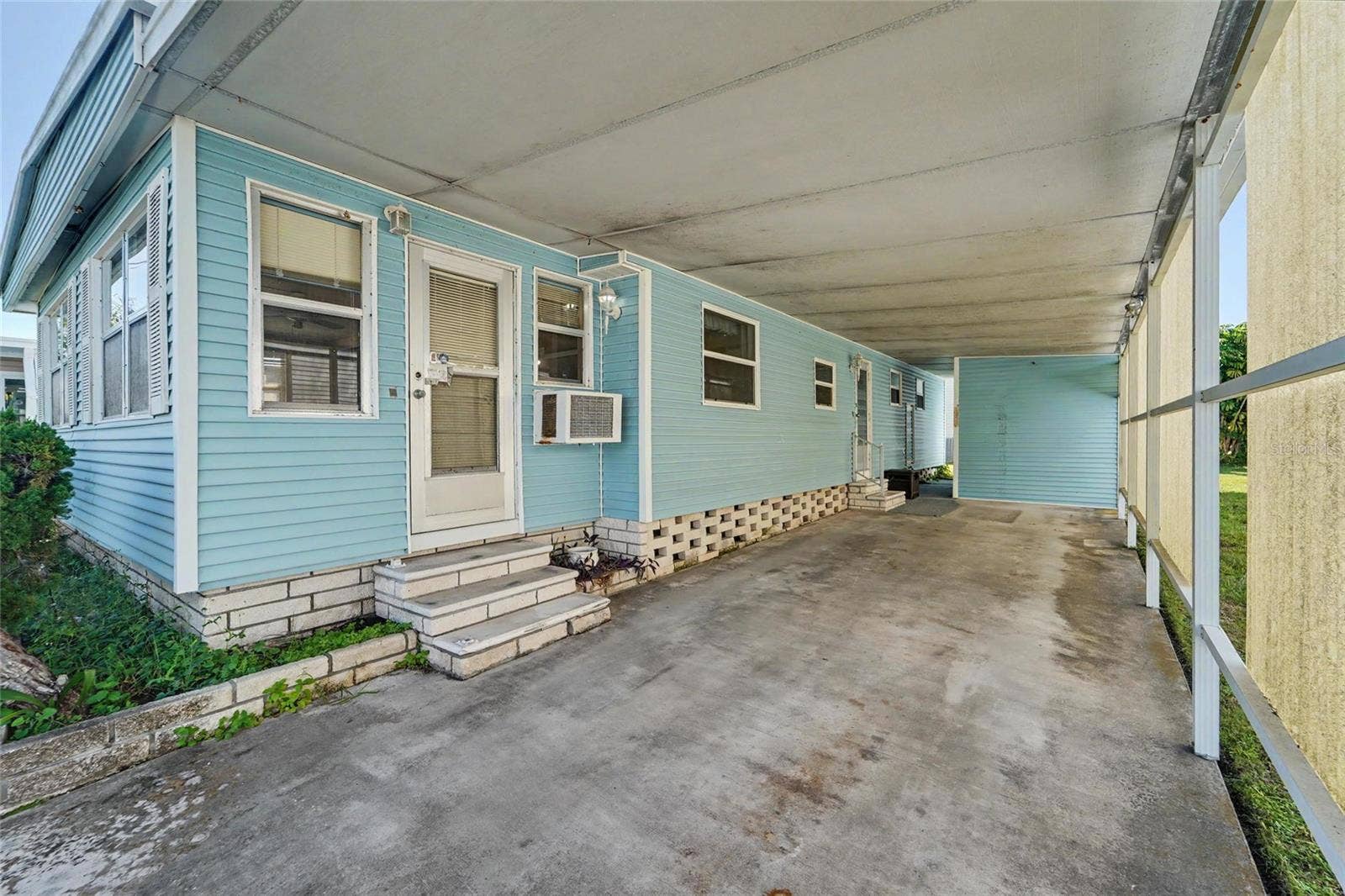 Large Carport and storage shed straight ahead