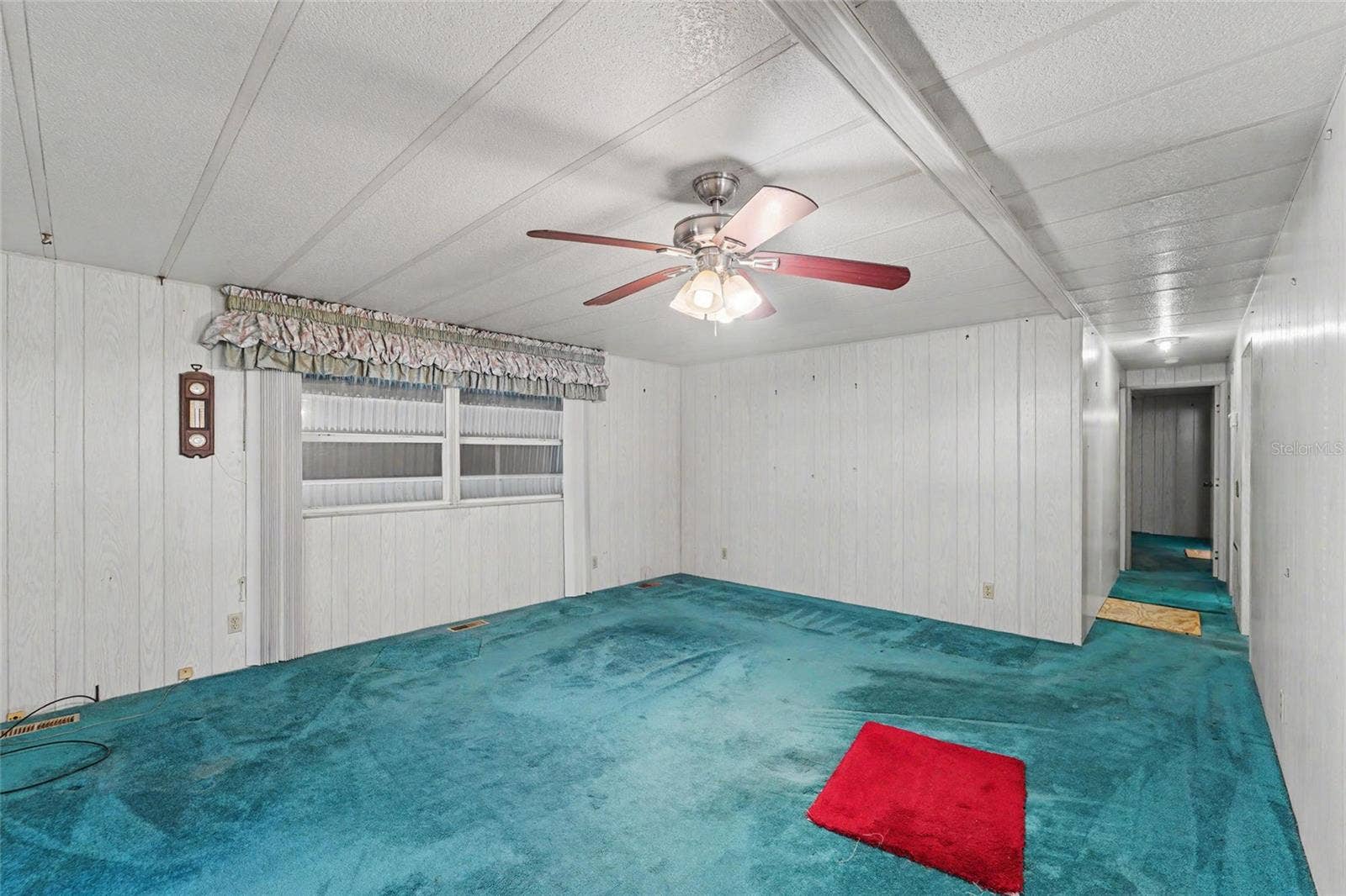 Large Living area - hurricane shutters are down and seen through the windows