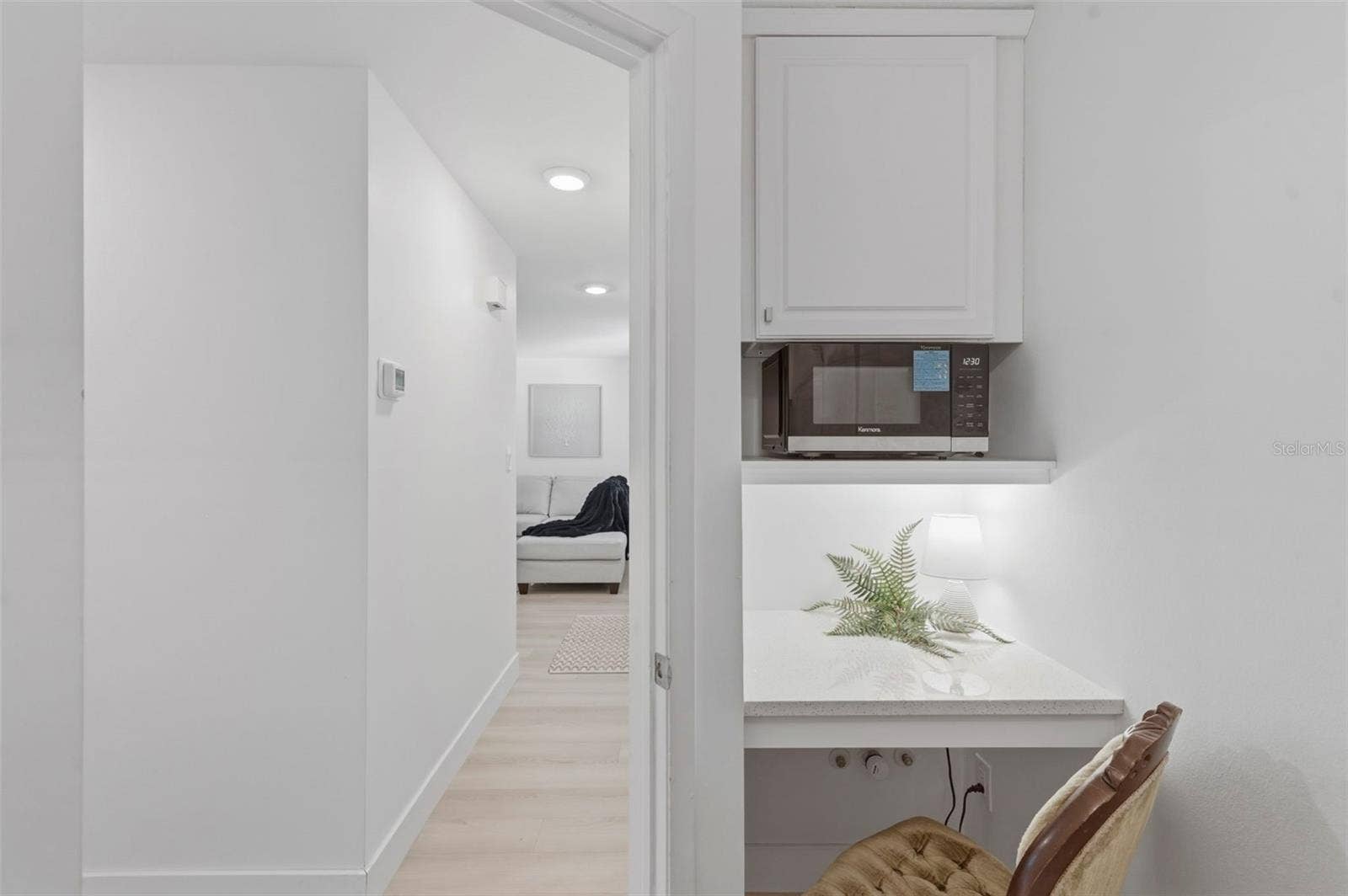 Desk area in laundry room with microwave, air fryer combo. storage