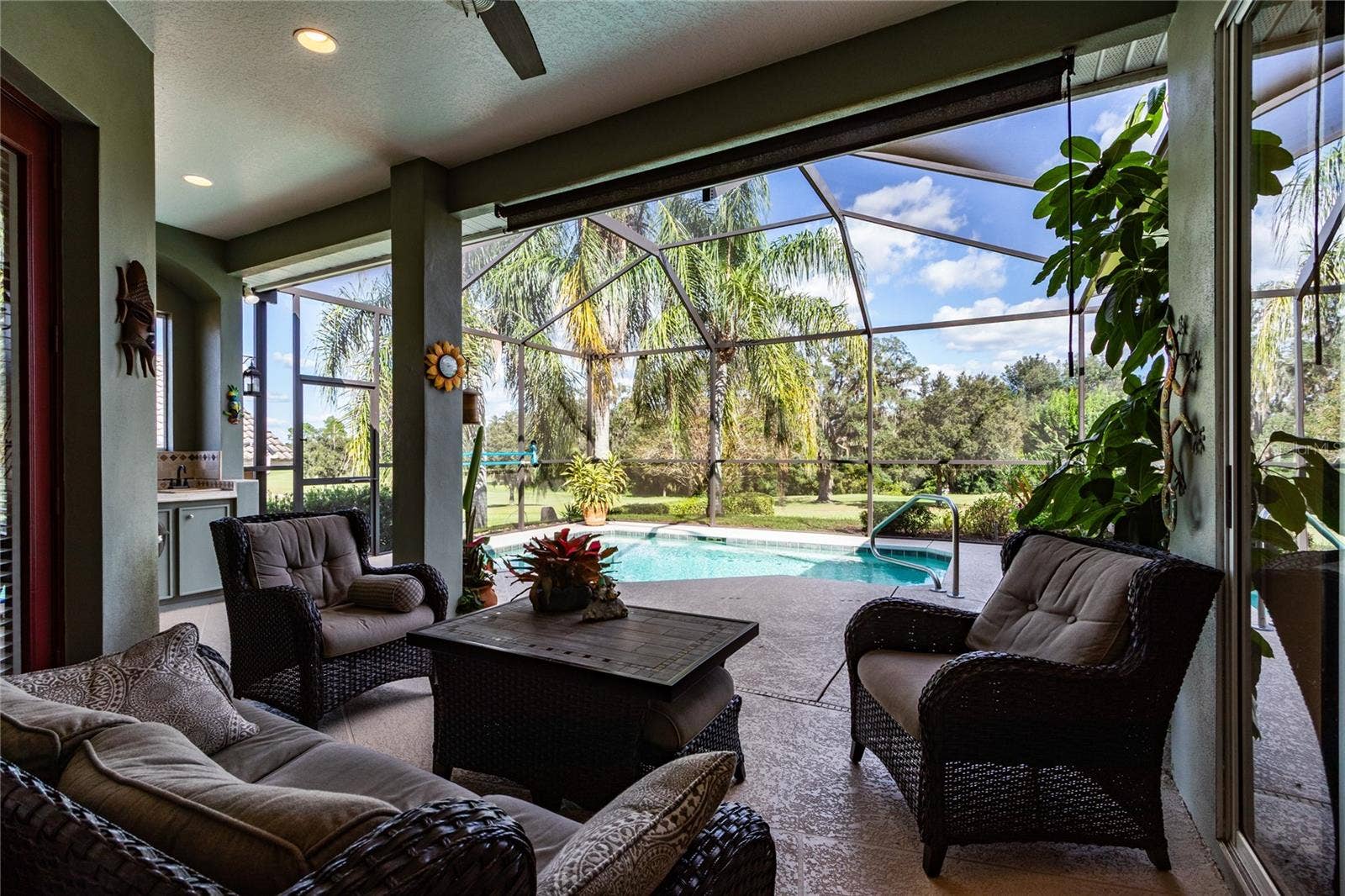 Covered lanai with fan overlooks pool and golf course