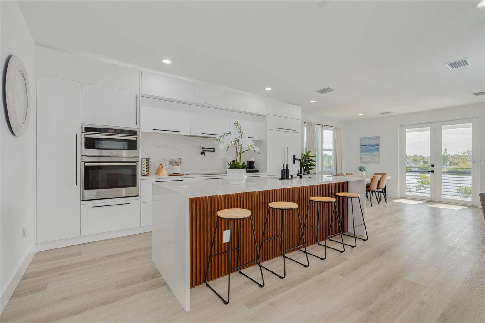7609 DEEDRA CIRCLE, Port Richey, FL 34668 Kitchen, dining and living area on main level with beautiful water views.