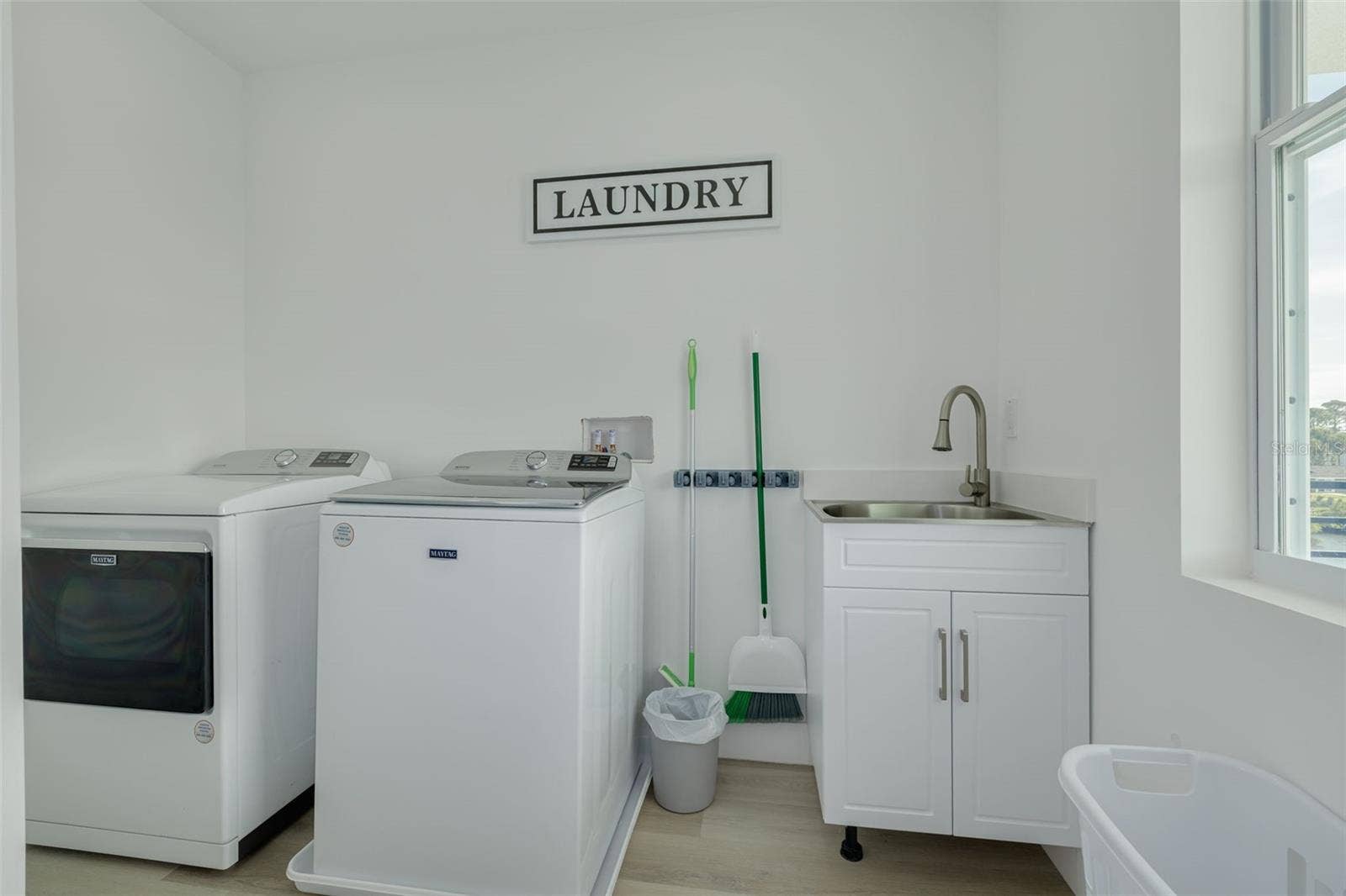 7609 DEEDRA CIRCLE, Port Richey, FL 34668 Laundry off loft area on the level with the three bedrooms.