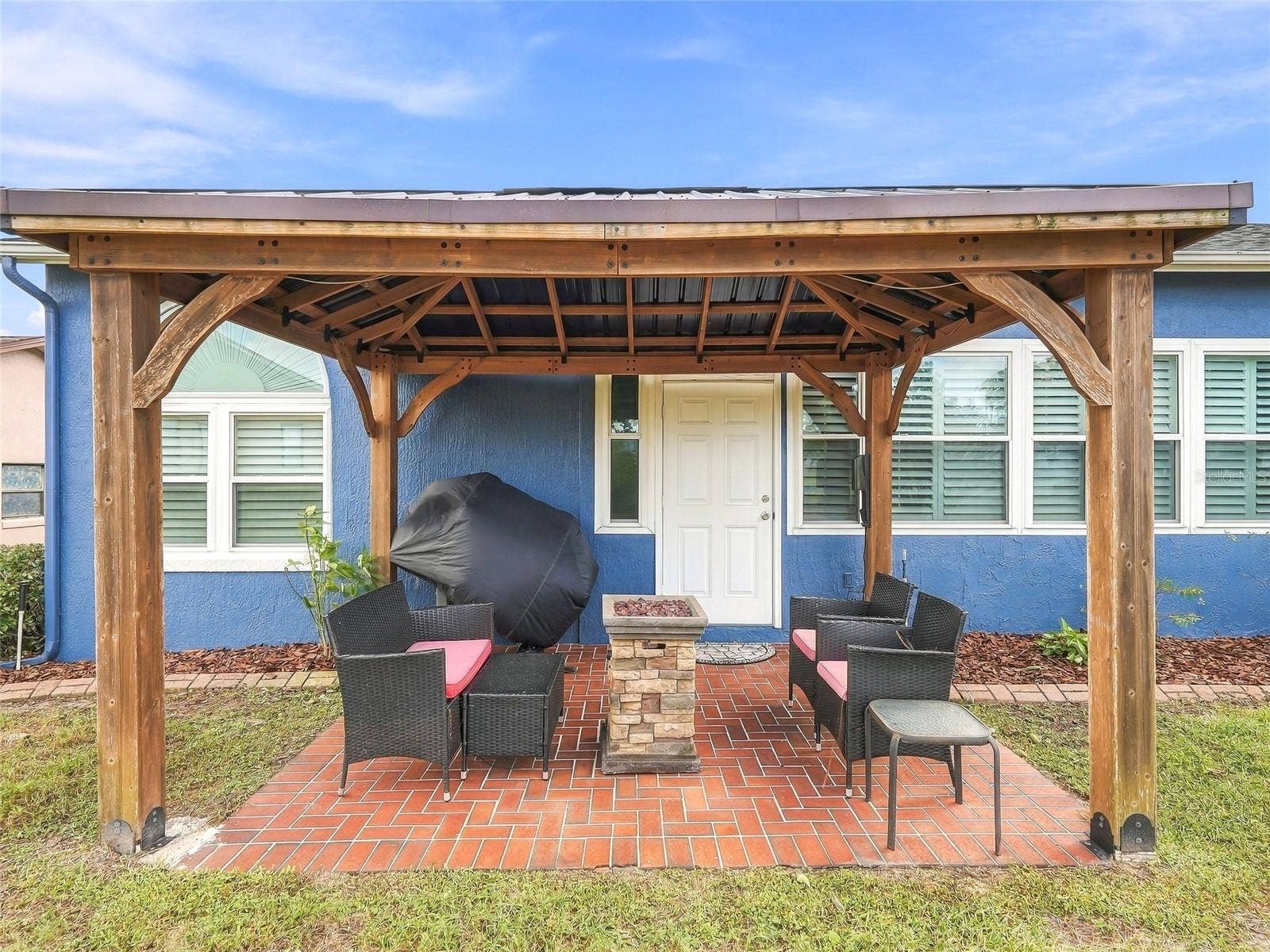 Pergola with chairs and fire pit
