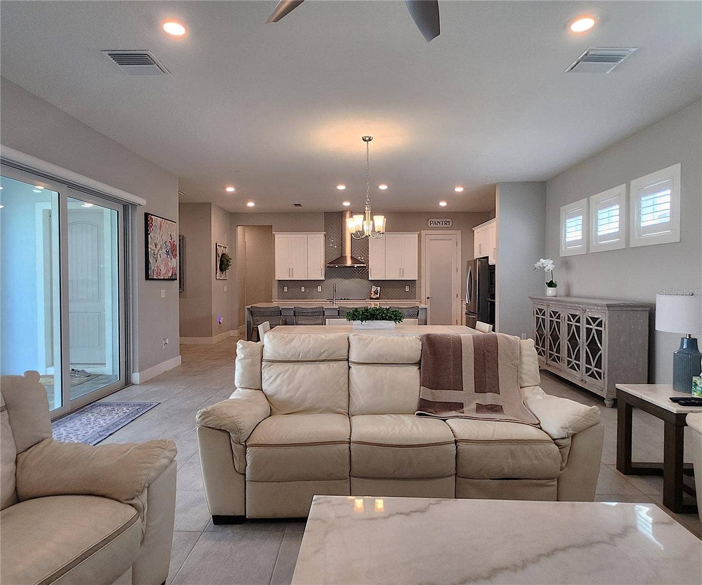 8896 DRUMMER PLANK DRIVE, Wesley Chapel, FL 33545 Main home: plantation shutters, remote controlled shade, large living room, dining area, large open kitchen, 3 bedrooms, 2 full bathrooms, 1 guest bathroom, interior laundry room