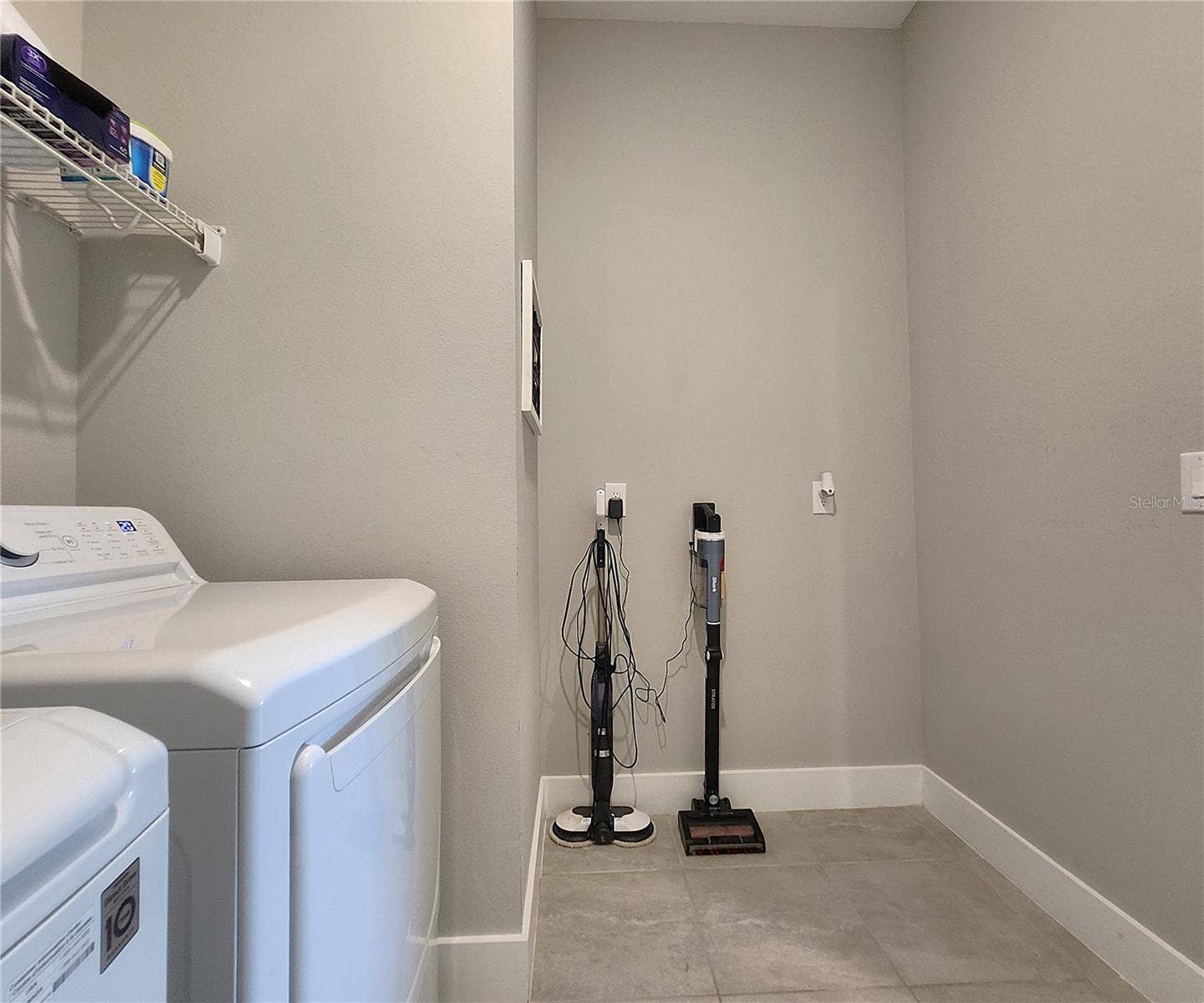 8896 DRUMMER PLANK DRIVE, Wesley Chapel, FL 33545 Interior Laundry Room includes side-by-side washer and dryer, ventilated shelves, and storage space