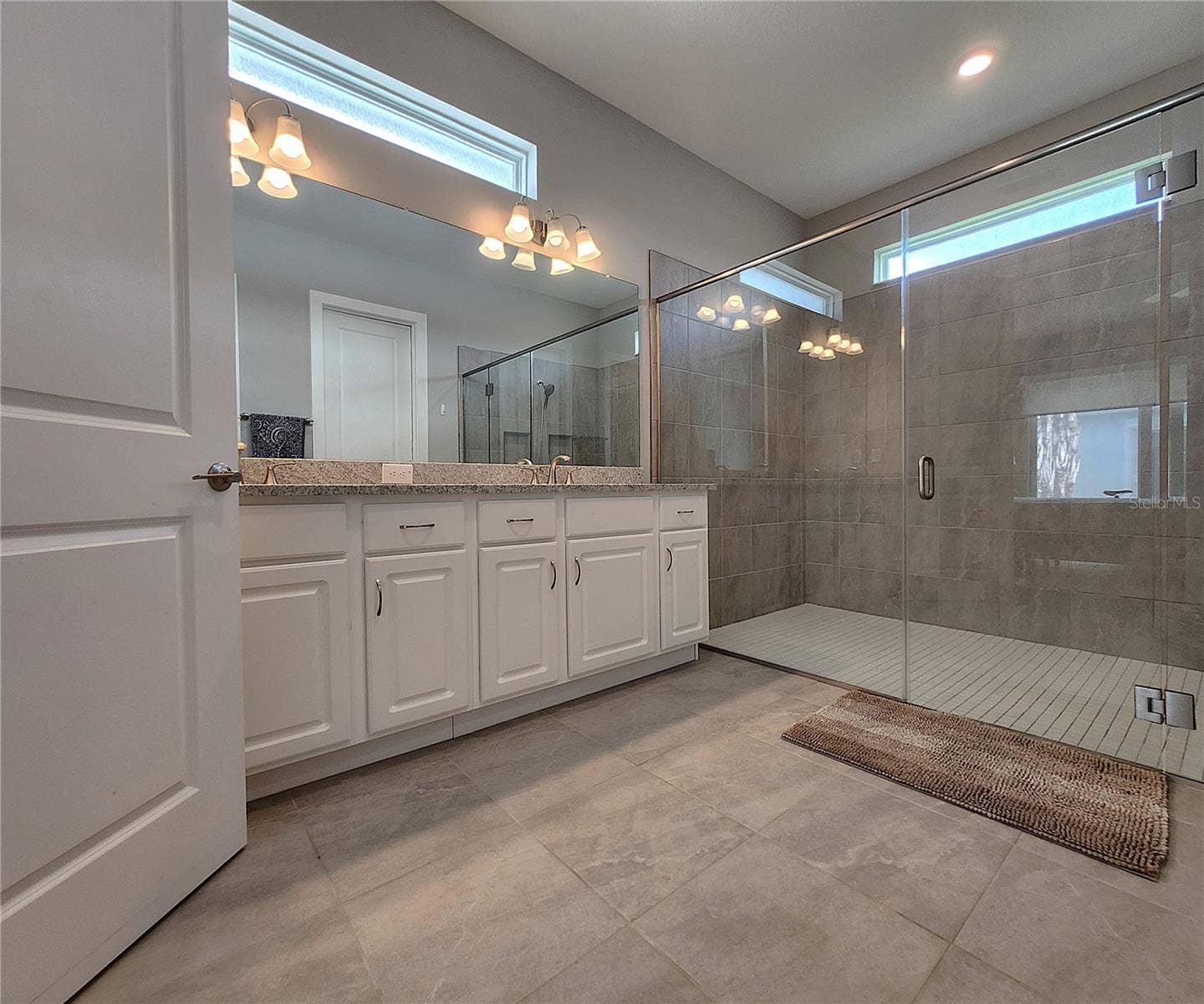 8896 DRUMMER PLANK DRIVE, Wesley Chapel, FL 33545 Master bathroom includes large walk-in tiled shower, water closet, walk-in closet, dual sink vanity, granite countertops