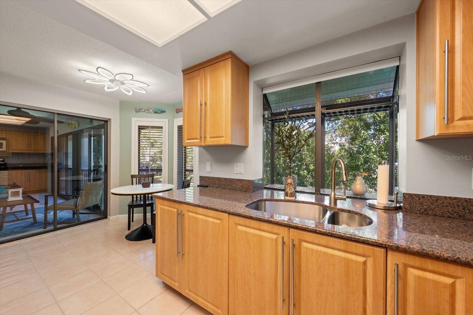 3079 LANDMARK BOULEVARD, #1608, Palm Harbor, FL 34684 Kitchen With Sliders Out To Rear Porch