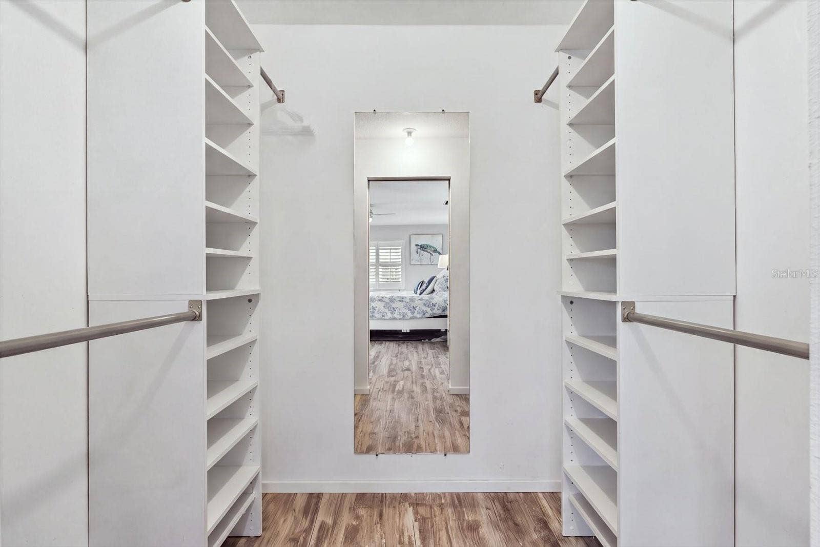 Primary Bedroom Closet with built in shelving