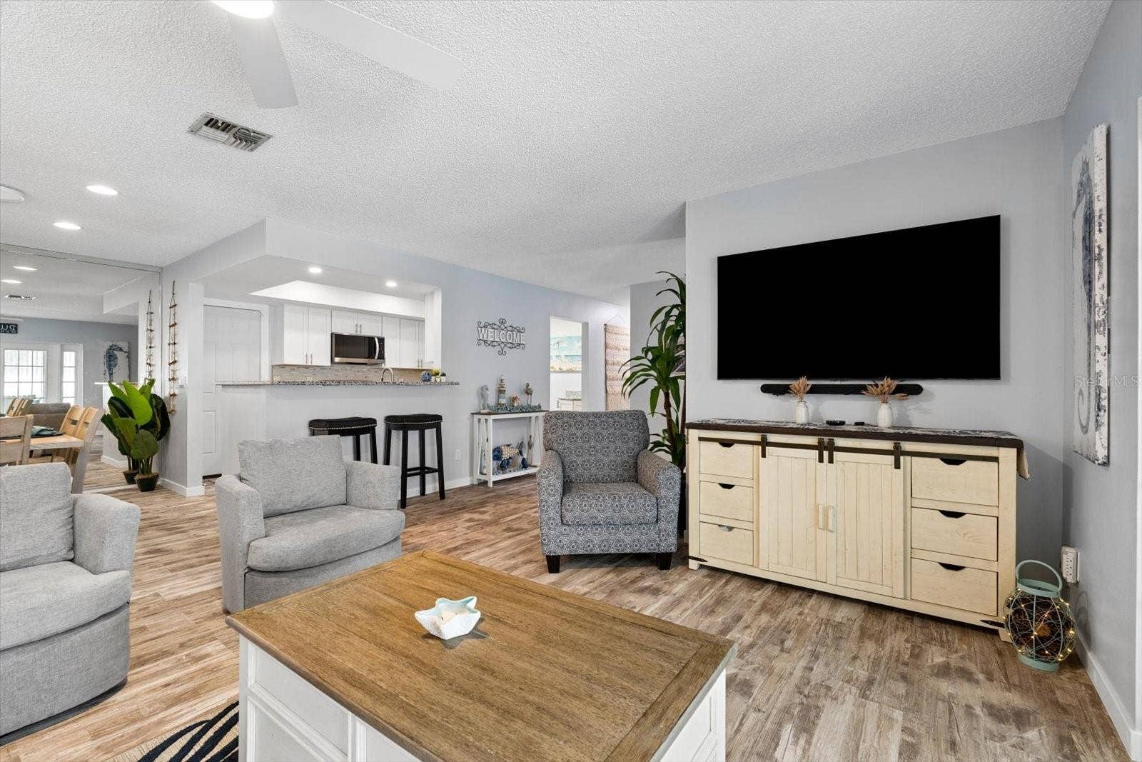 Open concept living room facing kitchen and dining room