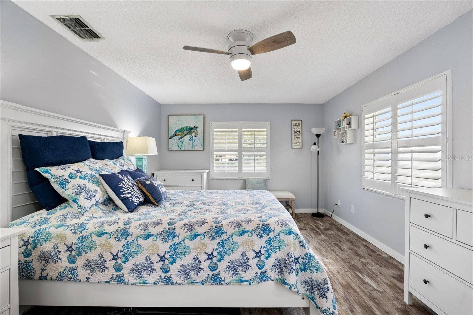 Primary bedroom with plantation shutters.