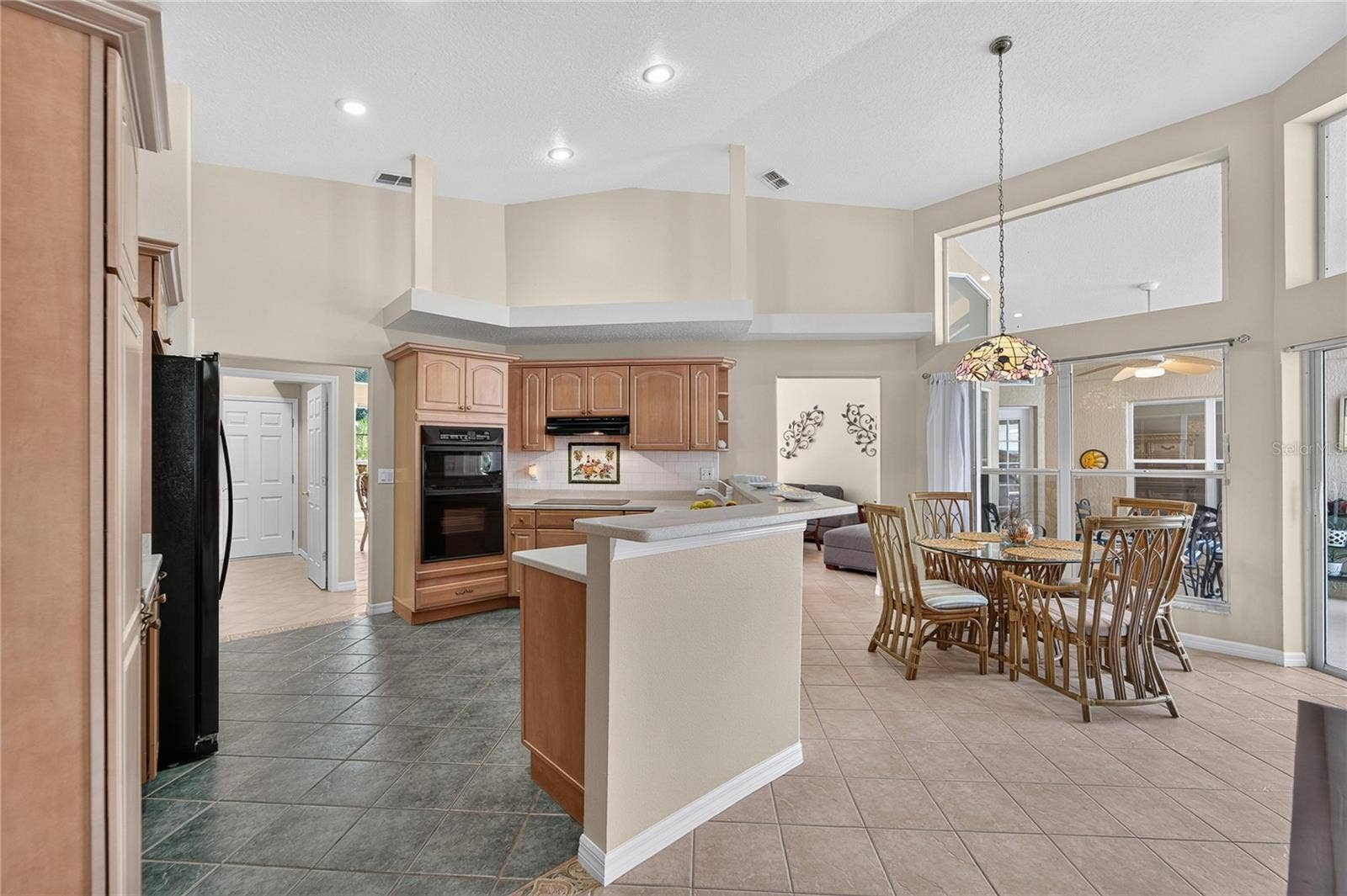 28329 LINDENHURST DRIVE, Wesley Chapel, FL 33544 Kitchen look over the pool area and has alot of light