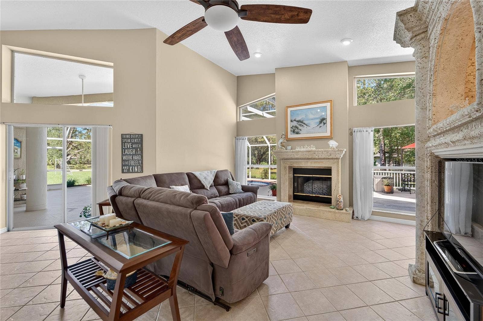 28329 LINDENHURST DRIVE, Wesley Chapel, FL 33544 Family room is open to the kitchen, overlooks the pool and has a wood burning fireplace
