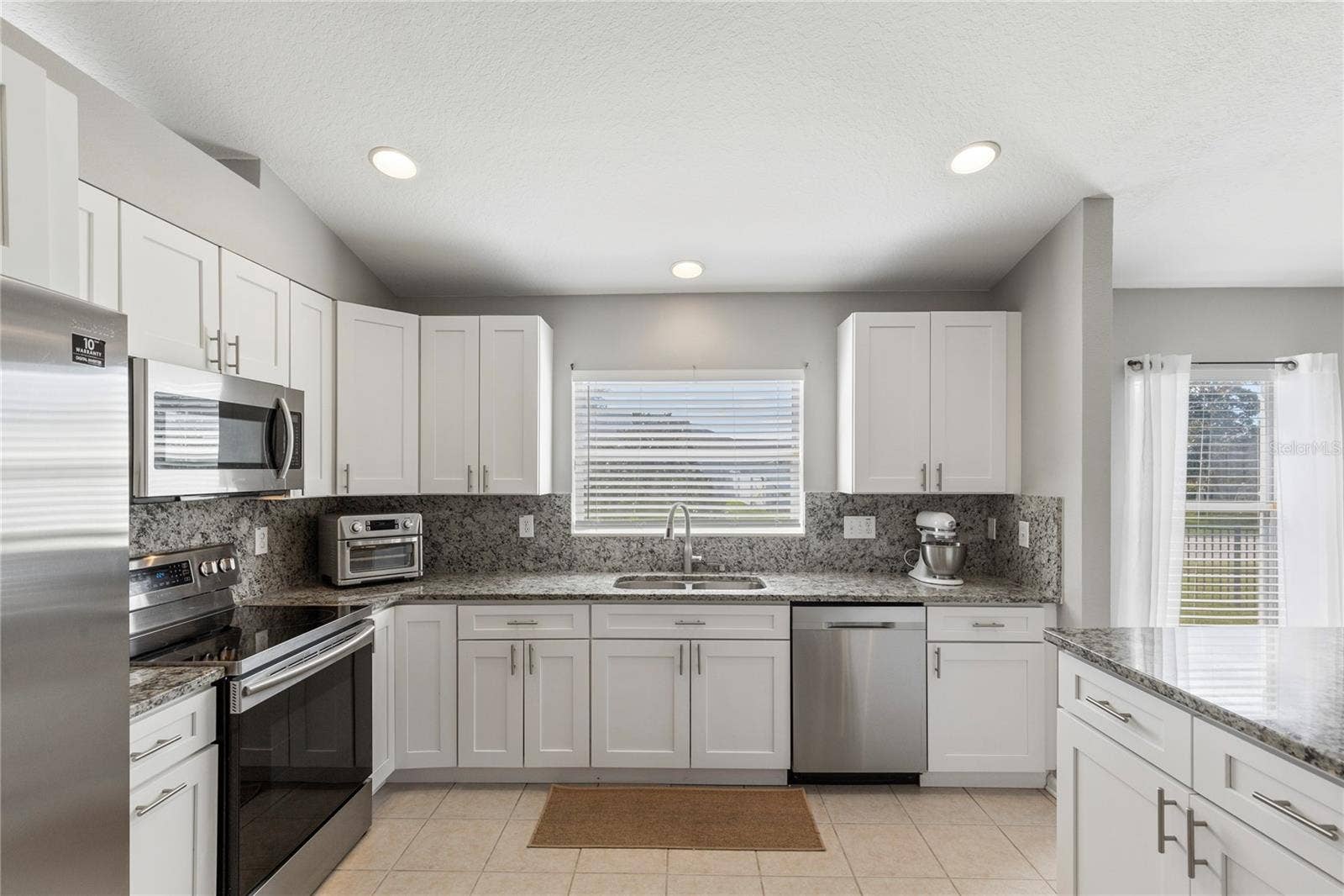 Renovated Kitchen with full slab backsplash