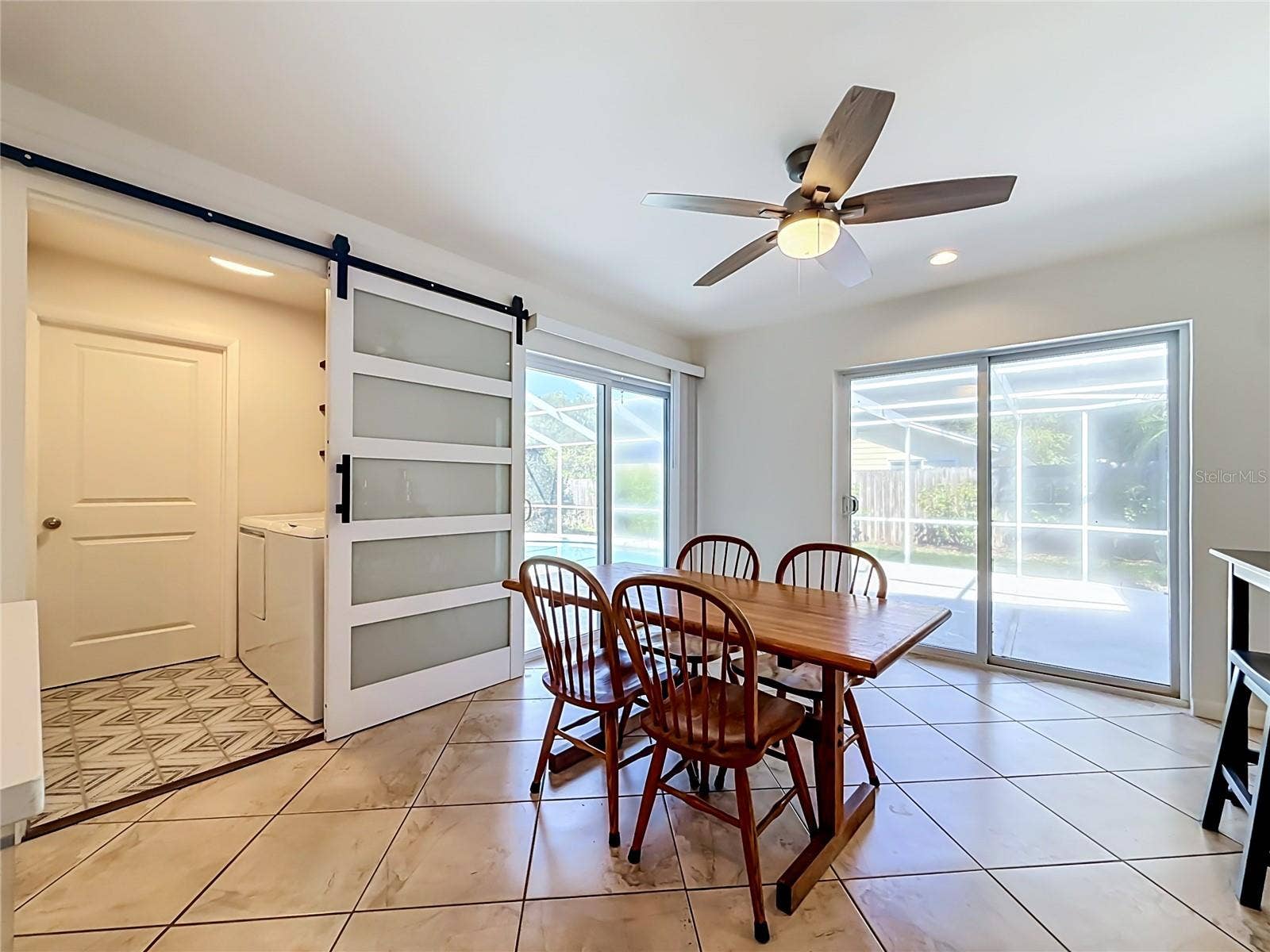 1852 SOURWOOD BOULEVARD, Dunedin, FL 34698 Dining Room - Outdoor Living and Pool Area - Laundry Room