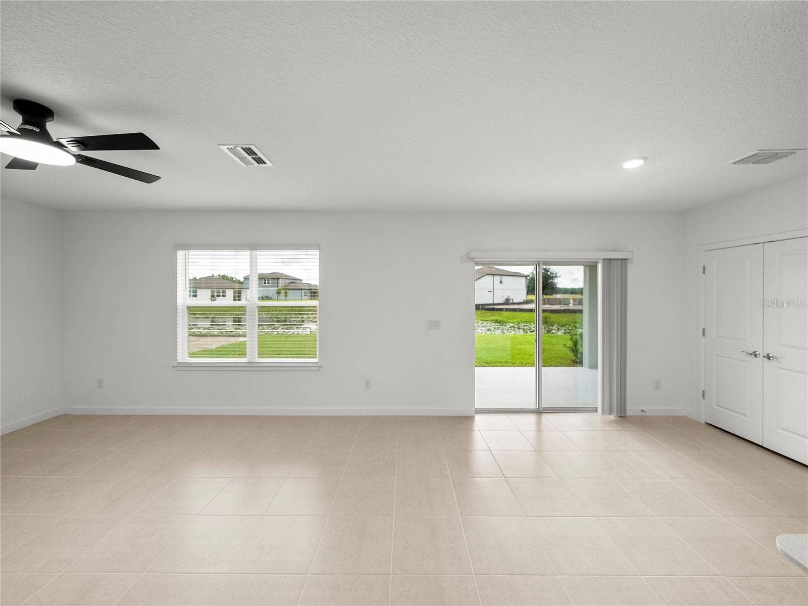1076 KISTNA DRIVE, Zephyrhills, FL 33540 Large Open Living and Dining area with New LED Ceiling Fan & Convenient Floor Outlet