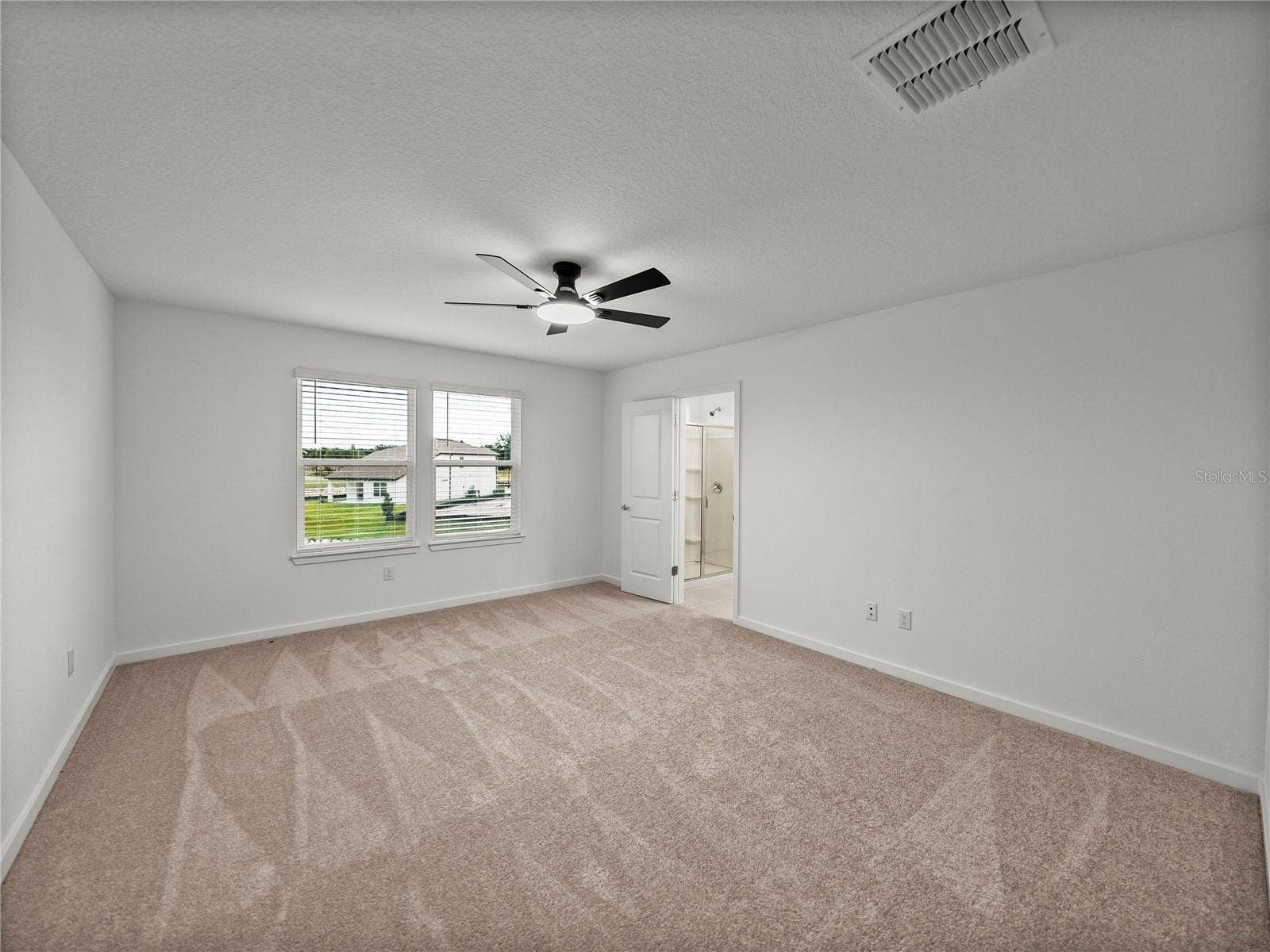 1076 KISTNA DRIVE, Zephyrhills, FL 33540 Primary Suite with New LED Ceiling Fan and Views to the Pond