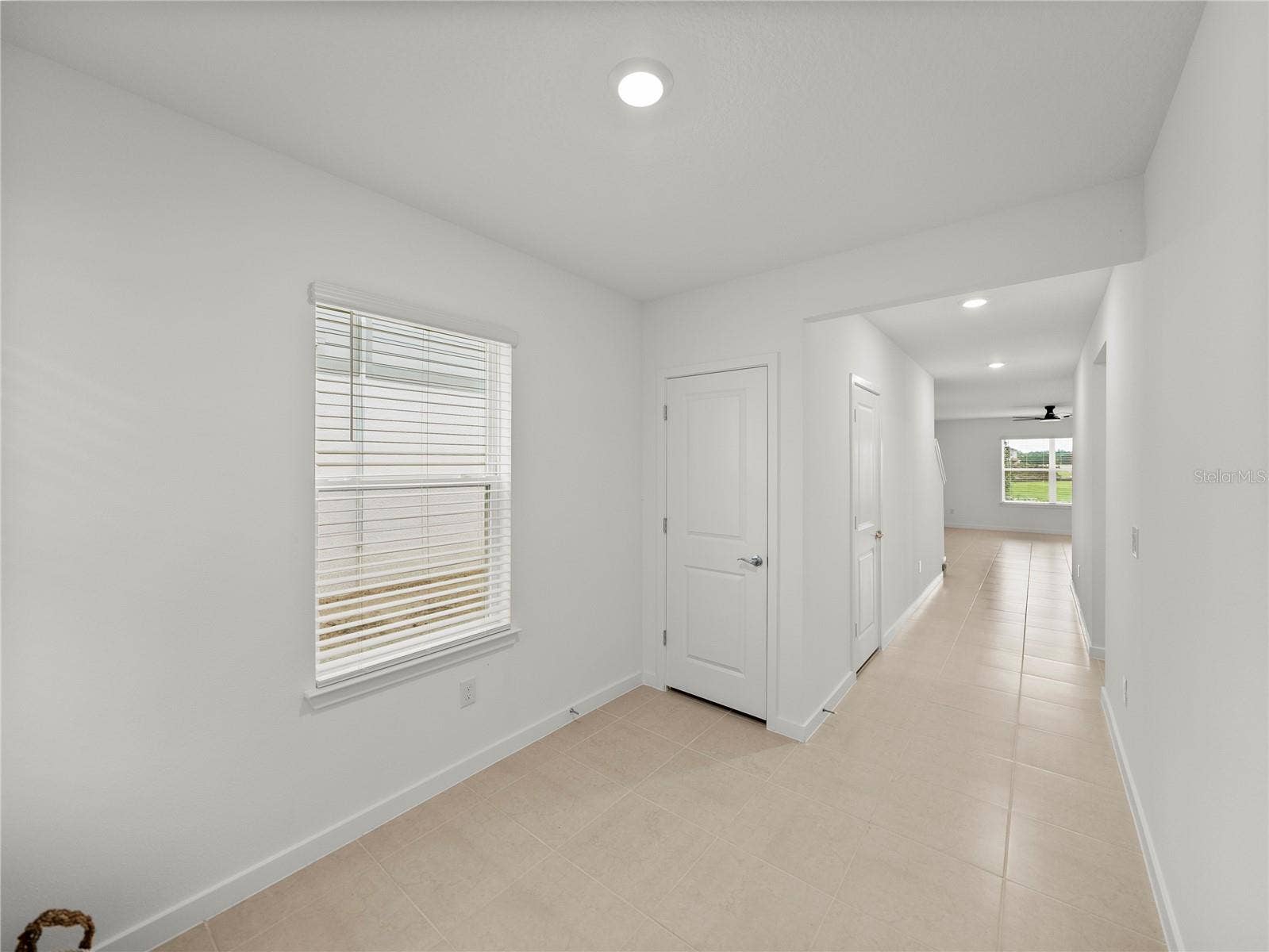 1076 KISTNA DRIVE, Zephyrhills, FL 33540 Foyer Mud Area with Coat Closet and Under Staircase Storage