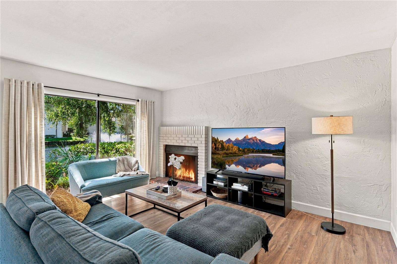 Charming Living Room Area with Beautiful Wood Burning Fireplace