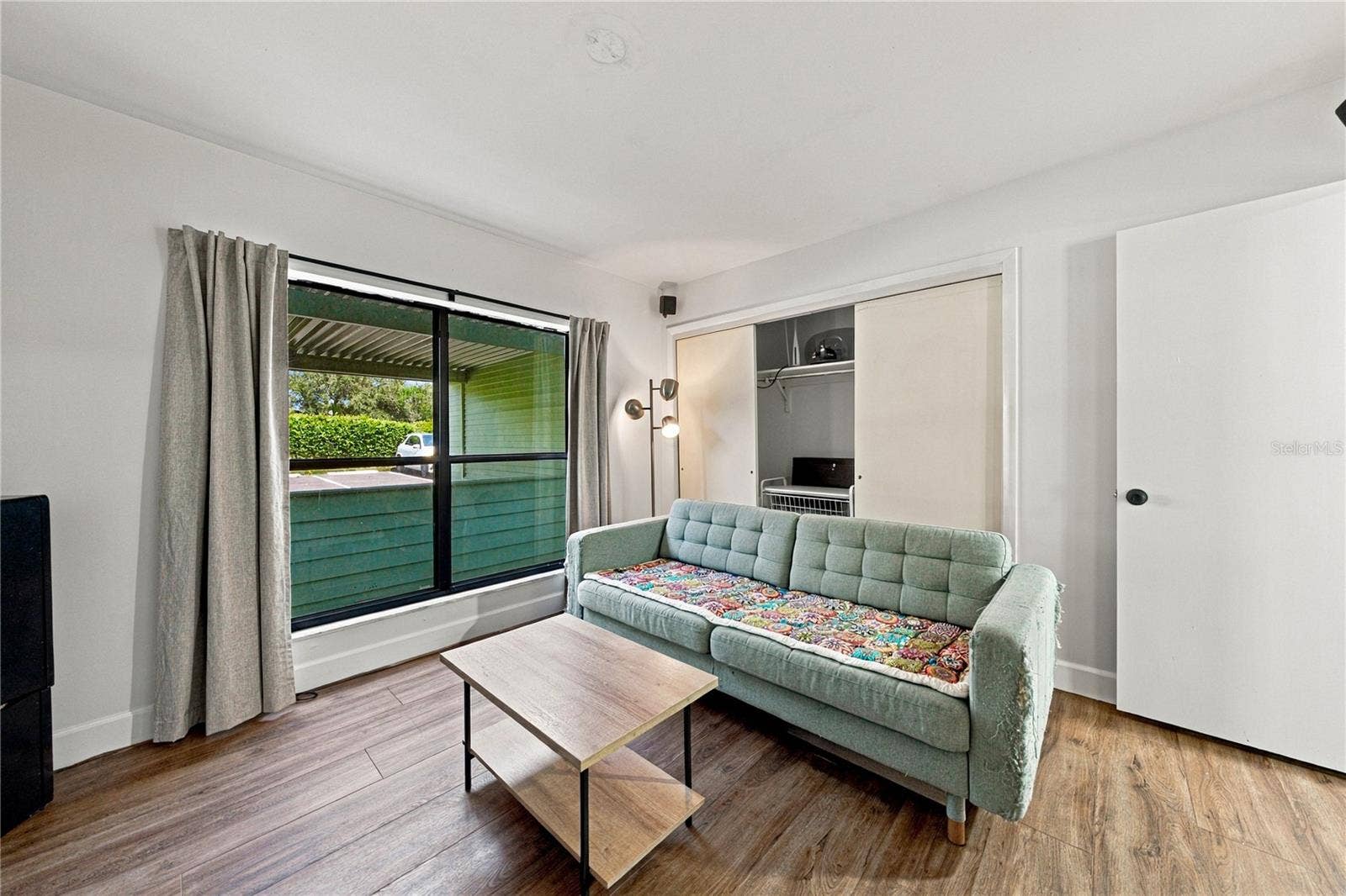 Second Bedroom used as a Movie Room with Plank Flooring and Large Closet