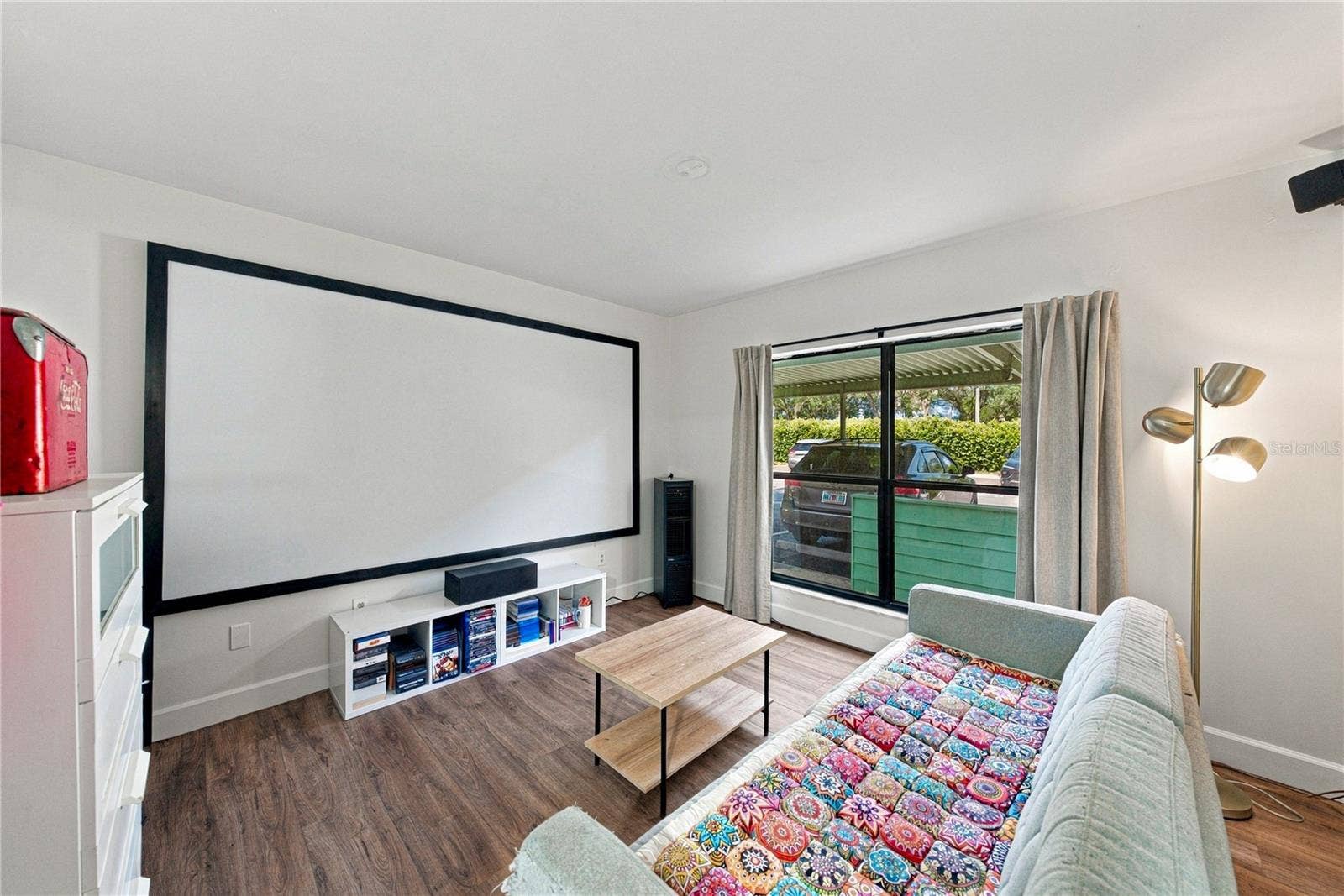 Second Bedroom used as a Movie Room with Plank Flooring and Large Closet
