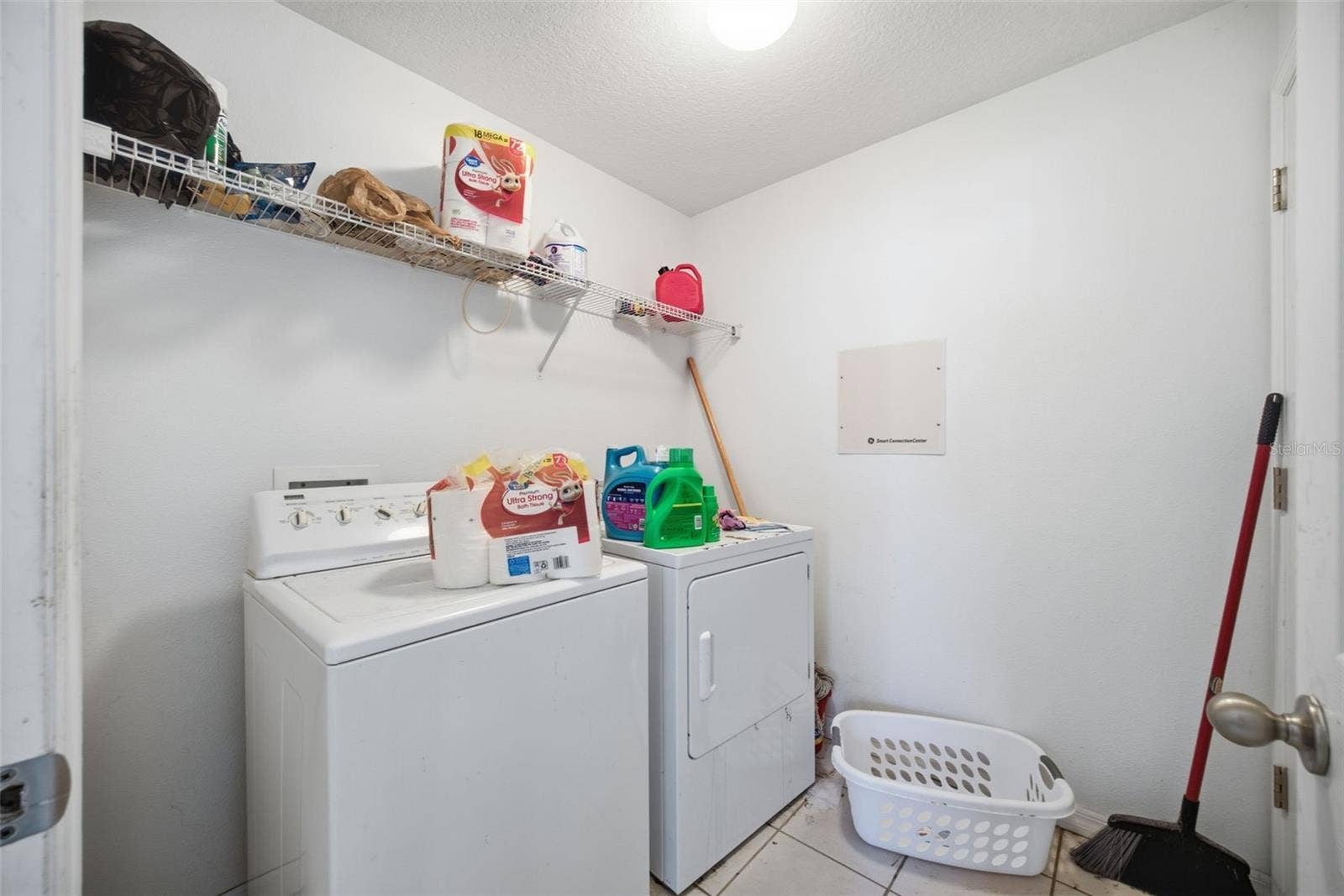 Indoor laundry room 7'0" x 6'7" with washer, dryer and wire shelving
