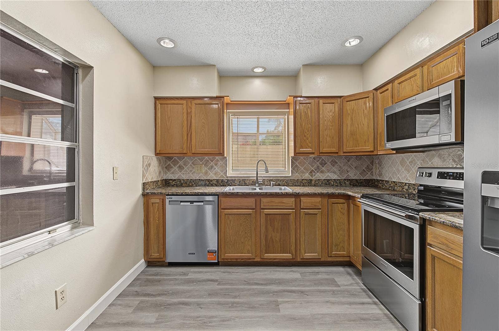 2729 FOXFIRE COURT, #C, Clearwater, FL 33761 Large kitchen with Stainless Steel Appliances, Patio off to the side.