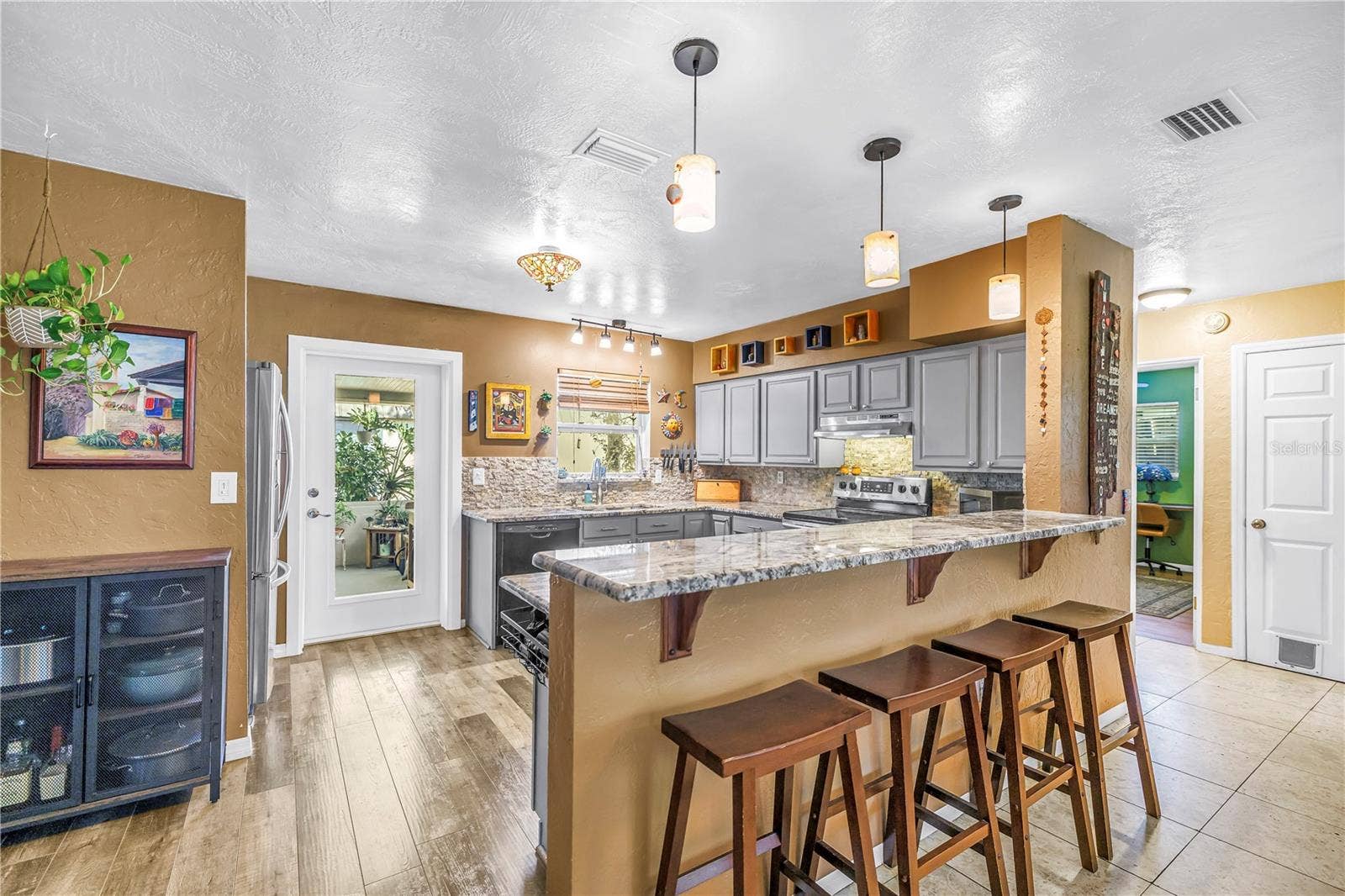 Updated kitchen with granite countertops, dimmable lighting and a glass panel door to access the back yard.