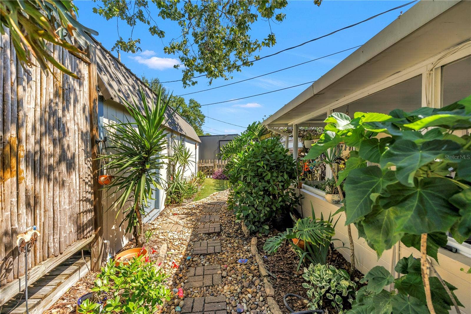 Garden path leading to workshop, gazebo and oversized secondary gated parking.