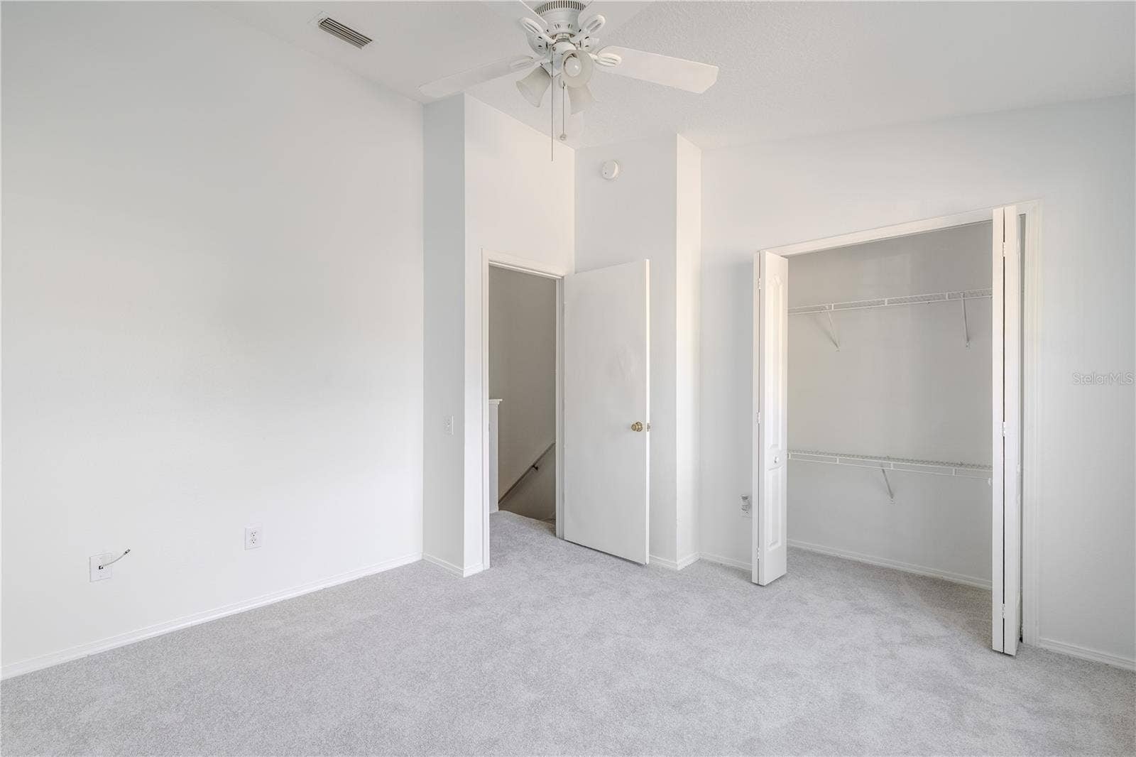 2432 LAKE WOODBERRY CIRCLE, Brandon, FL 33510 The 2nd bedroom features carpet, a ceiling fan with light kit and vaulted ceiling.