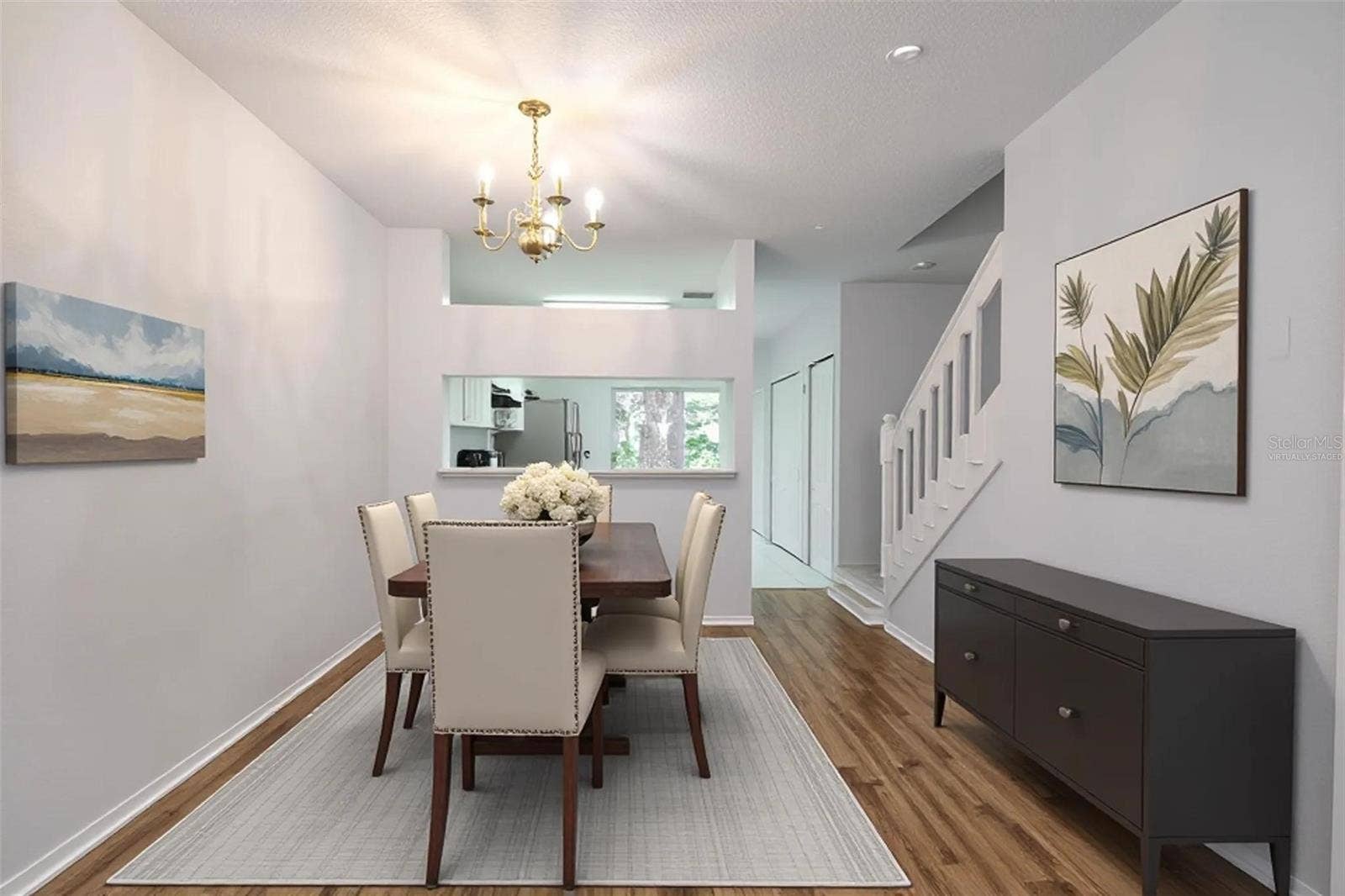2432 LAKE WOODBERRY CIRCLE, Brandon, FL 33510 Dining room features wood laminate flooring, a 6 light chandelier and a convenient pass thru to the kitchen. (Photo has been virtually staged.)