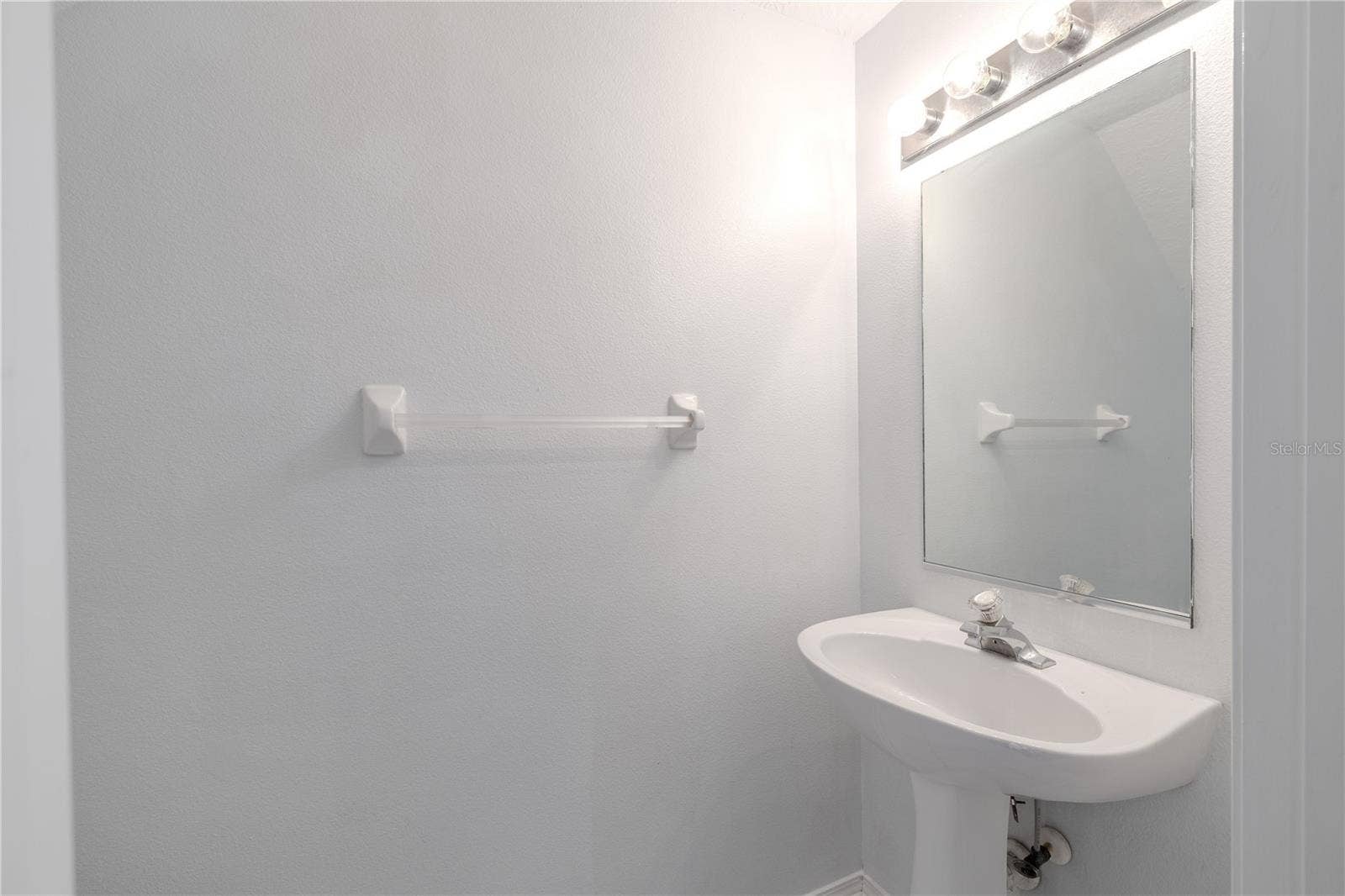 2432 LAKE WOODBERRY CIRCLE, Brandon, FL 33510 1st floor half bath off of the living room with pedestal sink and commode.