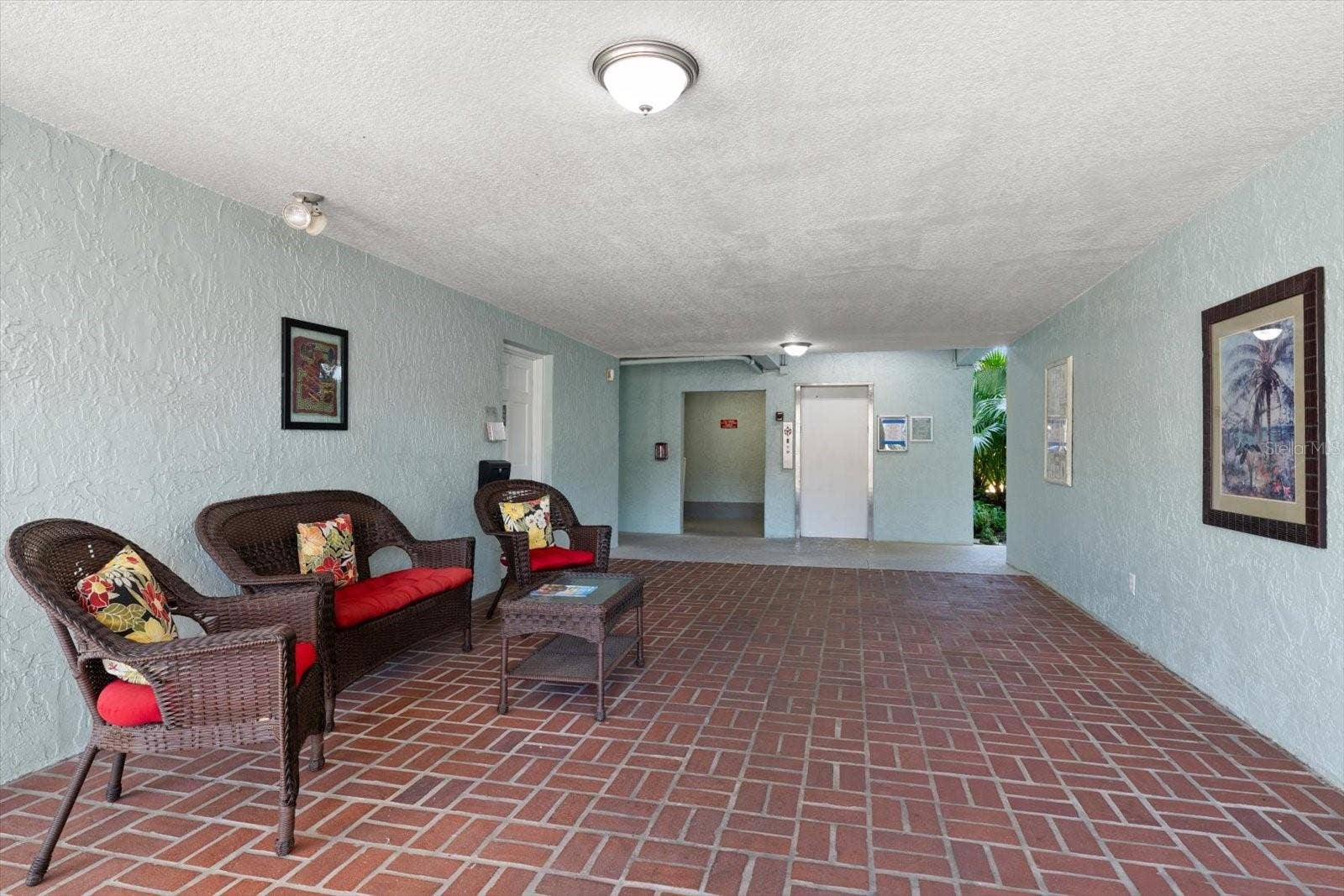 1706 BELLEAIR FOREST DRIVE, #238, Belleair, FL 33756 Ground floor building entrance to elevator, bike storage and laundry facility