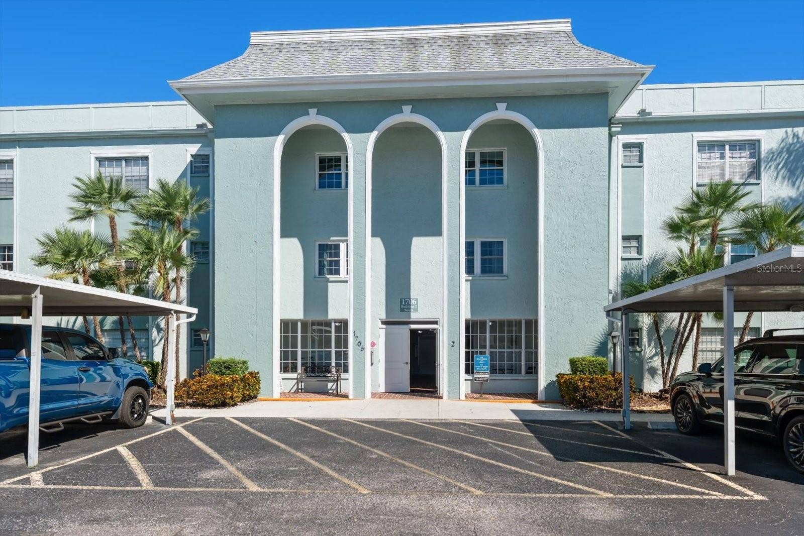 1706 BELLEAIR FOREST DRIVE, #238, Belleair, FL 33756 Front of condo building and carports