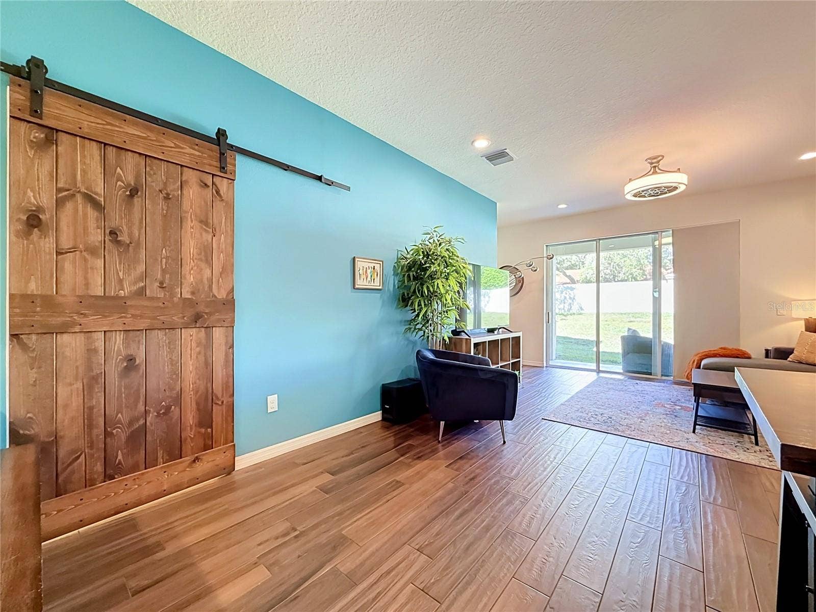 2270 MONTVIEW DRIVE, Clearwater, FL 33763 Custom wood barn door adds character to the downstairs half bath