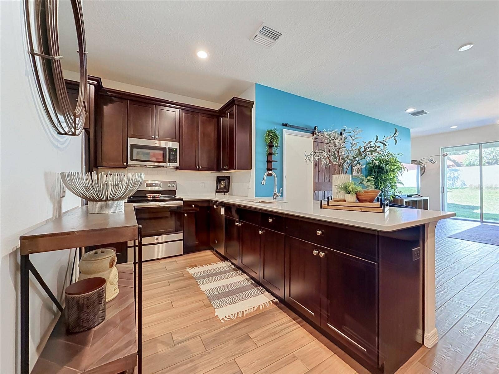 2270 MONTVIEW DRIVE, Clearwater, FL 33763 The well-appointed kitchen offers SOLID WOOD CABINETRY, GRANITE countertops, stainless steel appliances, a breakfast bar, and ample storage.