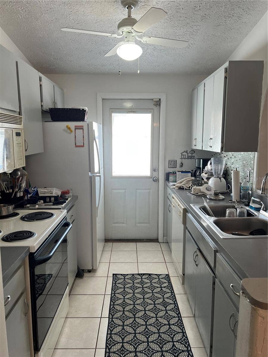 Kitchen also has an entry door to patio with built in blinds.