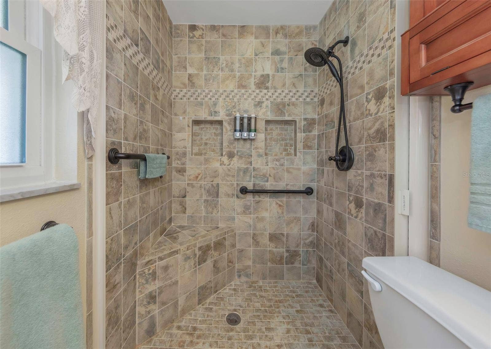 Oversized shower with built in seat.