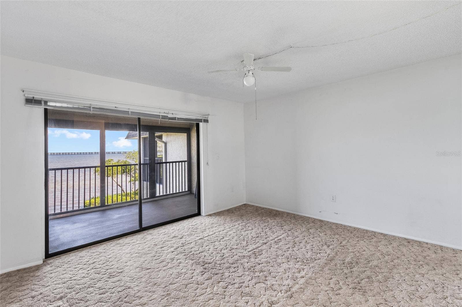 2980 HAINES BAYSHORE ROAD, #105, Clearwater, FL 33760 Primary bedroom over looking balcony with full panoramic water views.