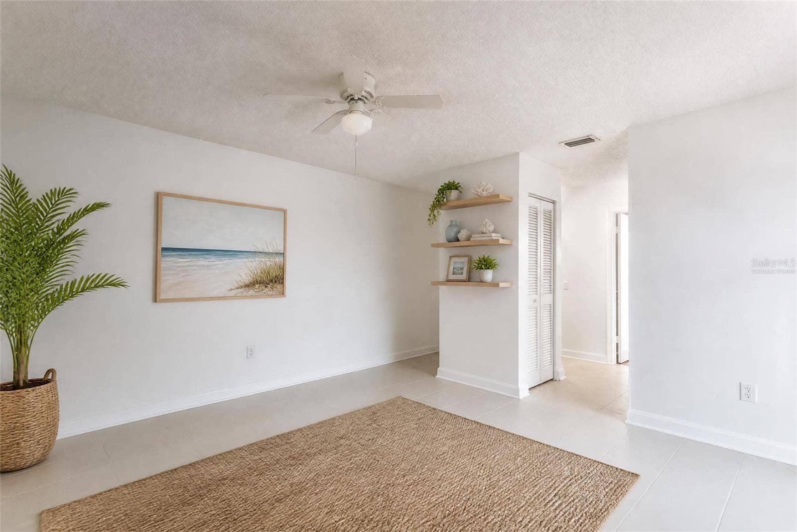 2980 HAINES BAYSHORE ROAD, #105, Clearwater, FL 33760 Virtually staged primary suite with tile floors and shelves. Assist in envisioning different flooors