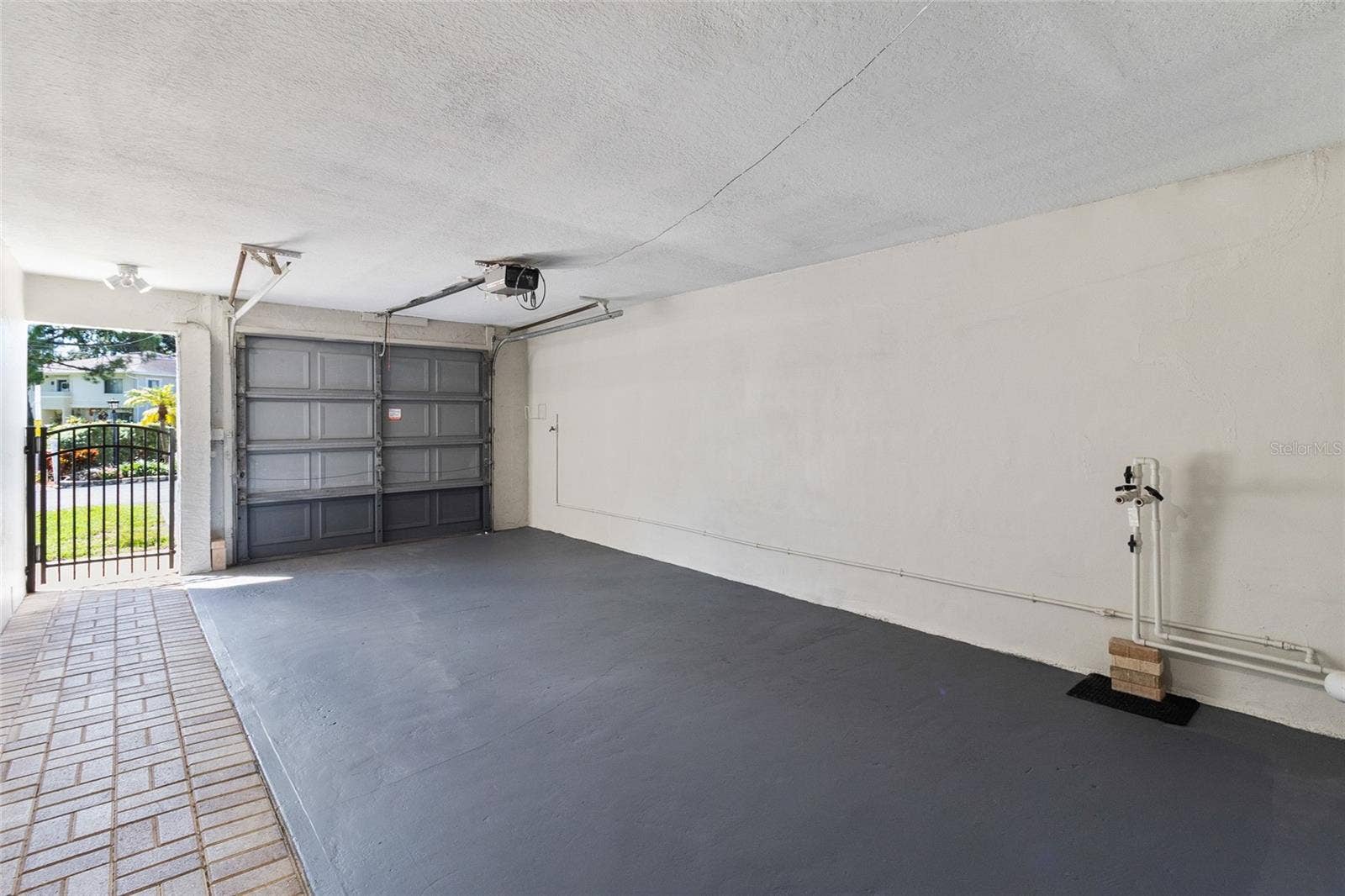 2980 HAINES BAYSHORE ROAD, #105, Clearwater, FL 33760 Open concept garage with door, opener and hookup for water softner