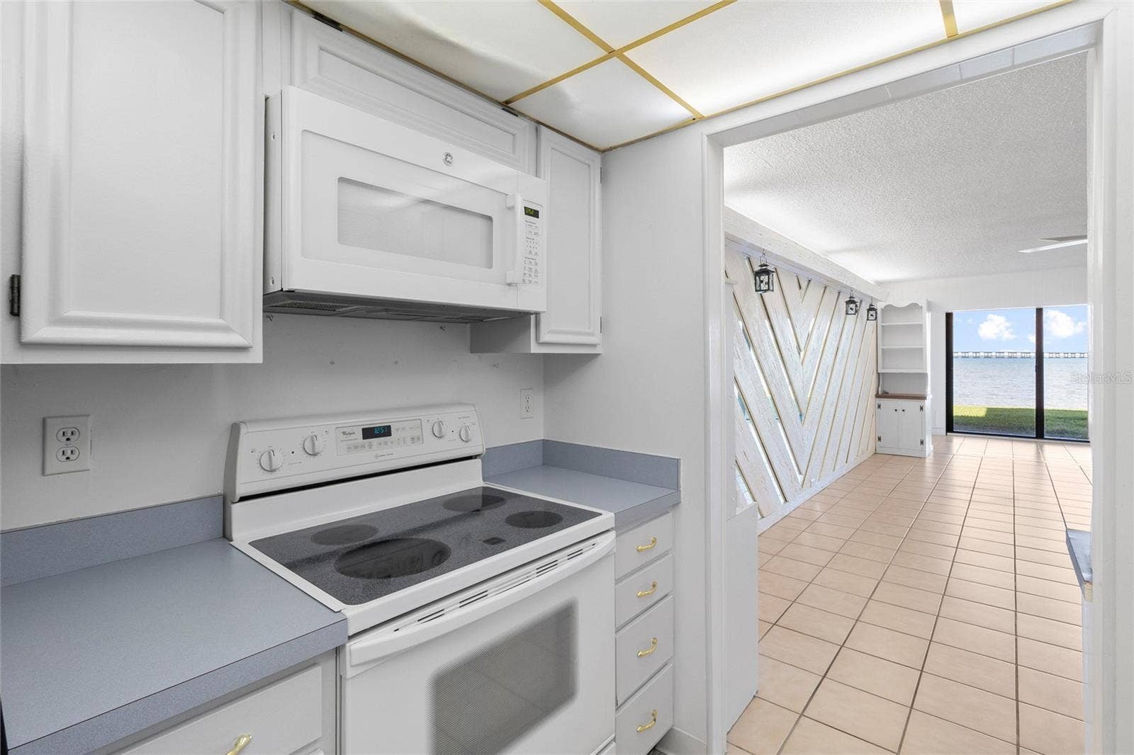 2980 HAINES BAYSHORE ROAD, #105, Clearwater, FL 33760 Kitchen looking toward water view.