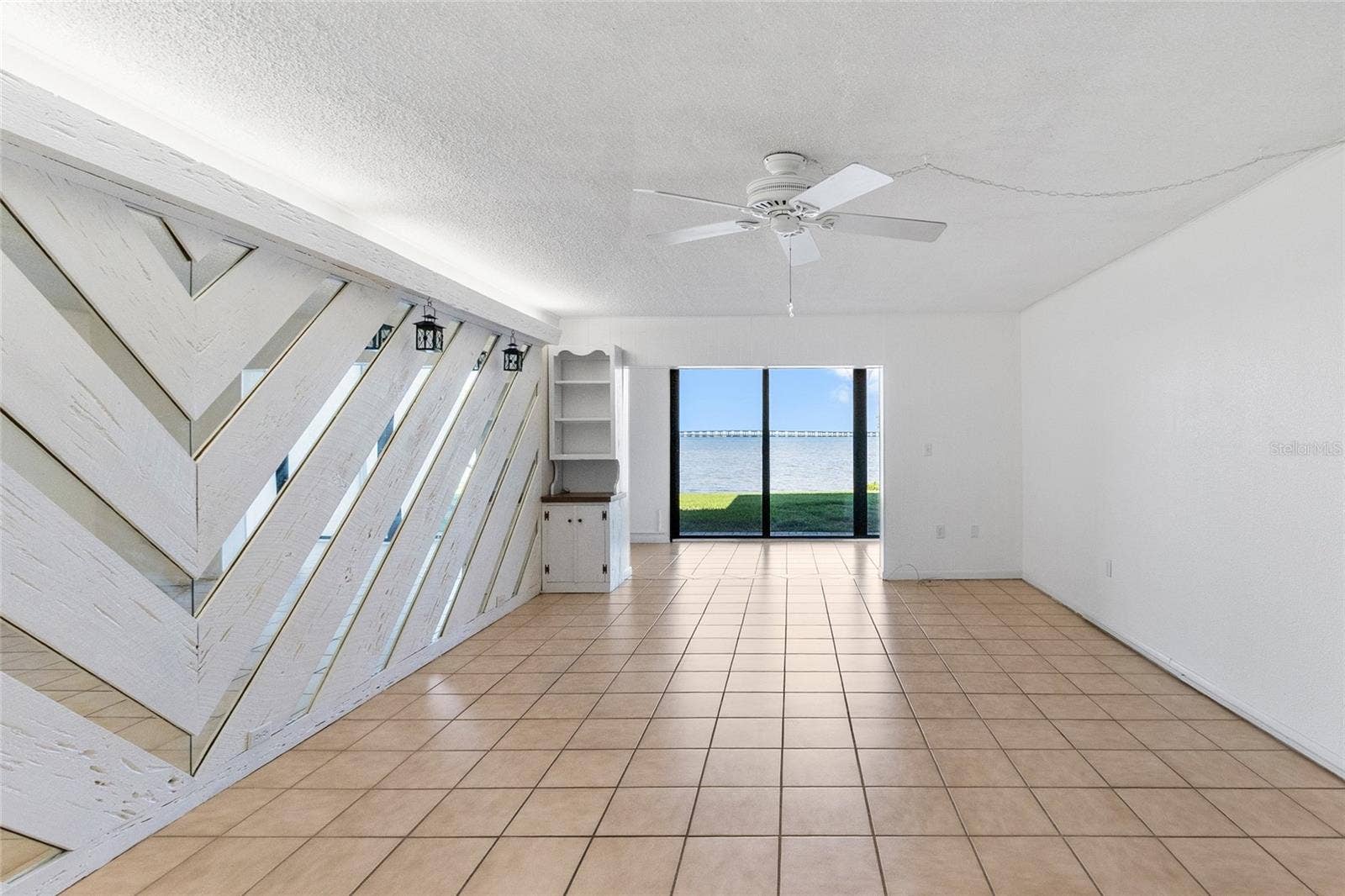 2980 HAINES BAYSHORE ROAD, #105, Clearwater, FL 33760 Living room looking directly towards sunroom and water view.
