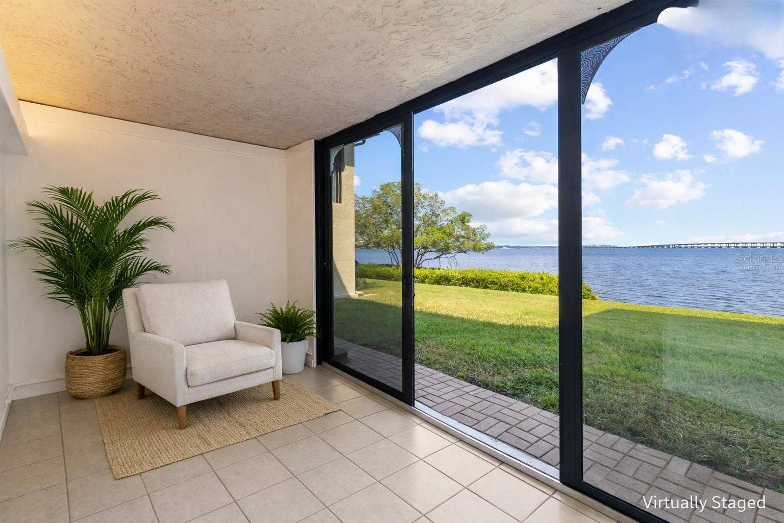2980 HAINES BAYSHORE ROAD, #105, Clearwater, FL 33760 Virtually staged sunroom from other side - with panoramic water views