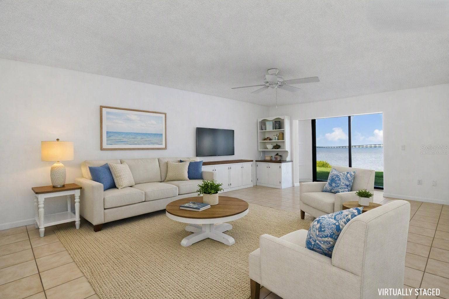 2980 HAINES BAYSHORE ROAD, #105, Clearwater, FL 33760 Virtually staged living area with different wall finish - overlooking water view.