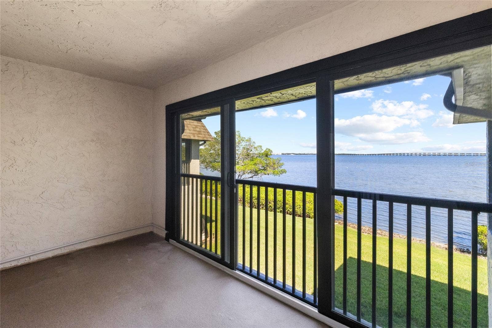 2980 HAINES BAYSHORE ROAD, #105, Clearwater, FL 33760 Balcony off primary bedroom - full panoramic water views